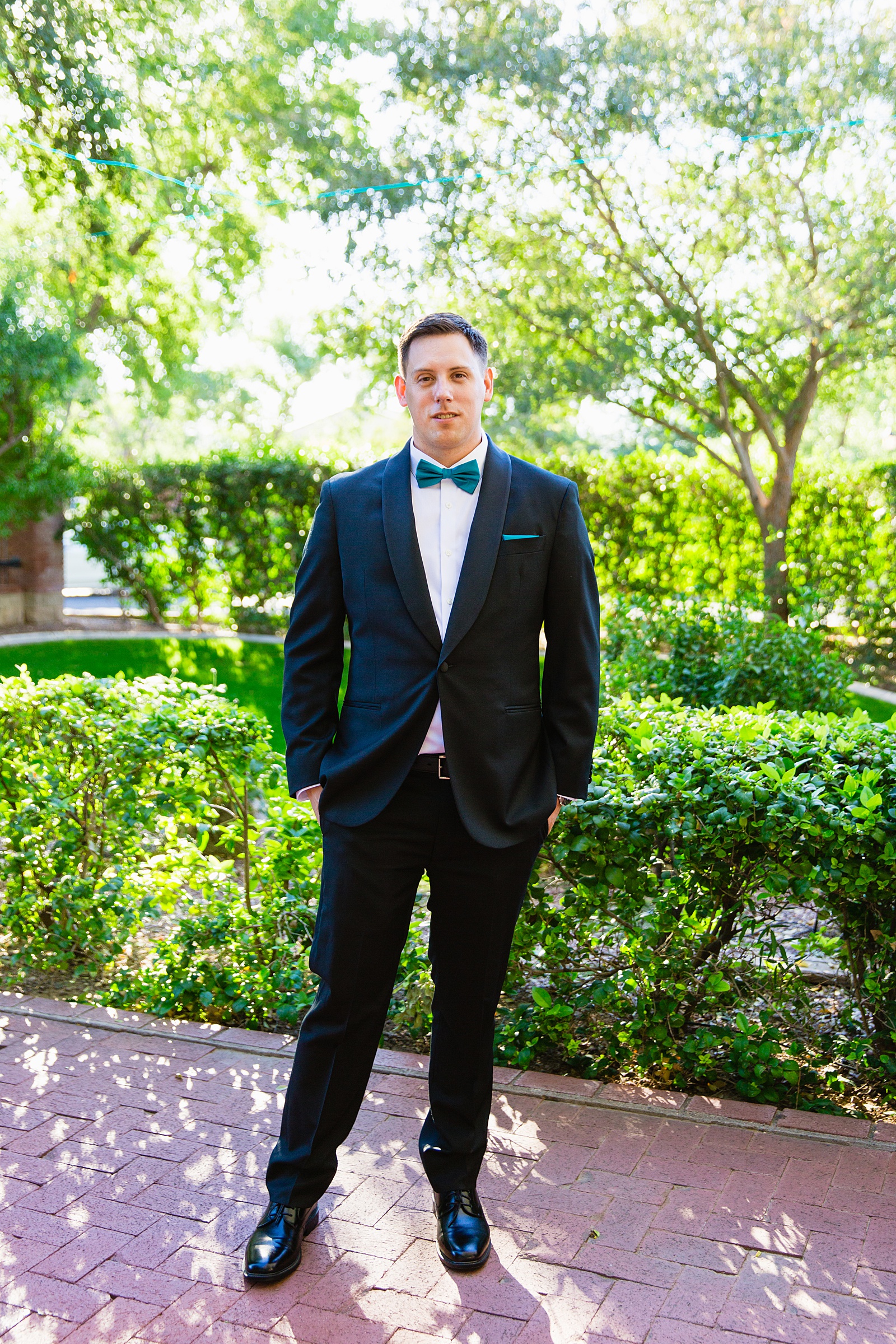 Groom's black suit with teal details suit for his Stonebridge Manor wedding by PMA Photography.