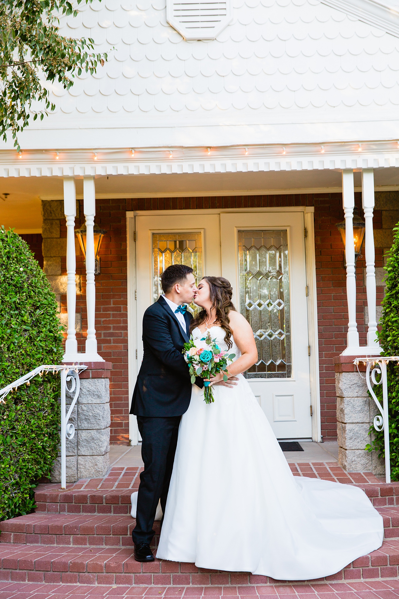 Bride and groom share a kiss during their Stonebridge Manor wedding by Arizona wedding photographer PMA Photography.