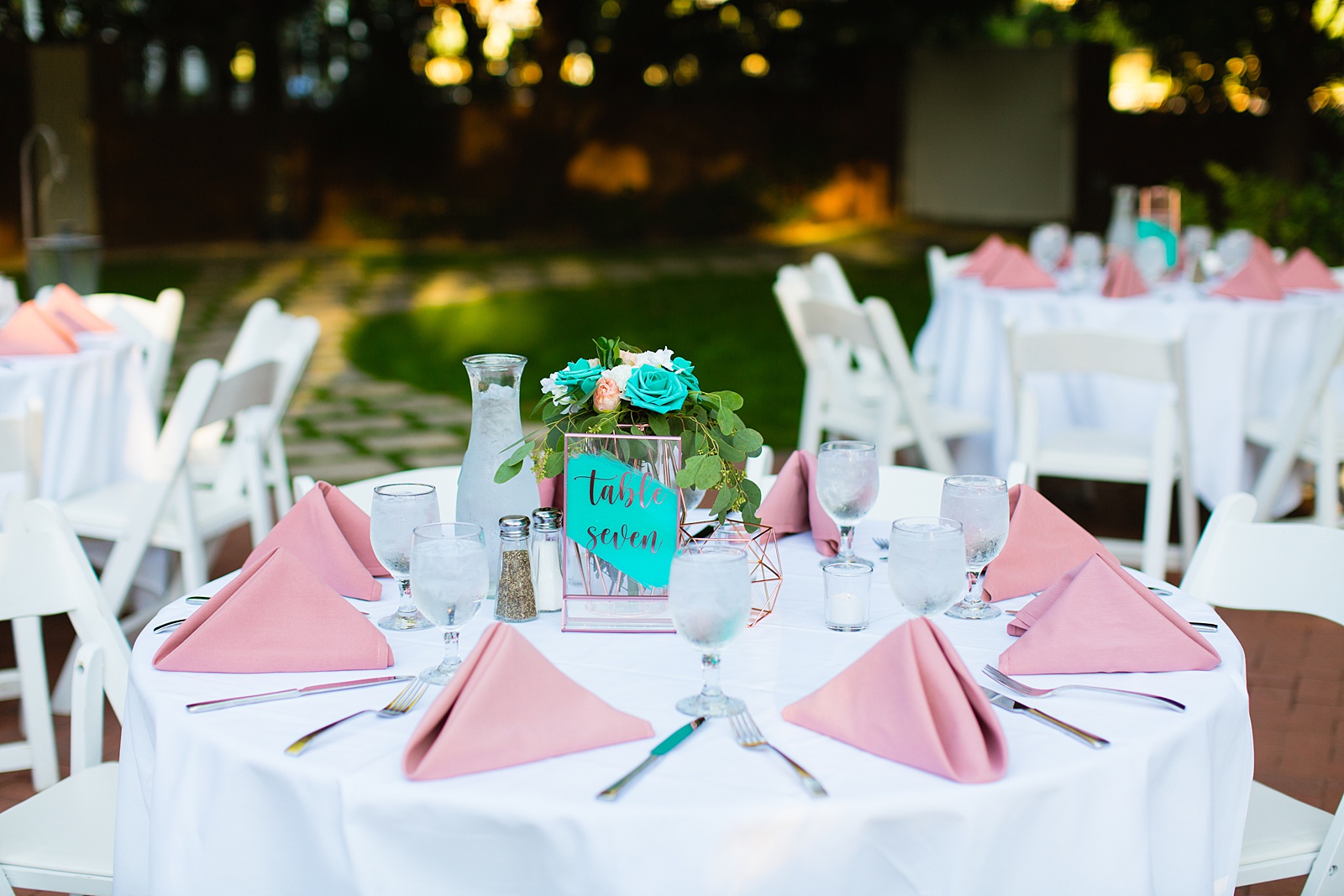 Pink and teal garden wedding reception table at a Stonebridge Manor wedding by Mesa wedding photographer PMA photography.