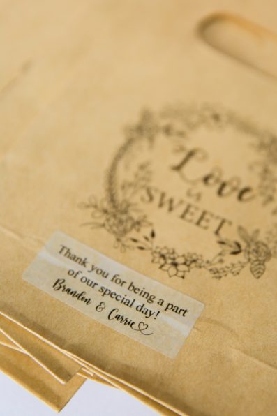 Custom Love is Sweet wedding favor bags for a candy table at the wedding reception by PMA Photography.