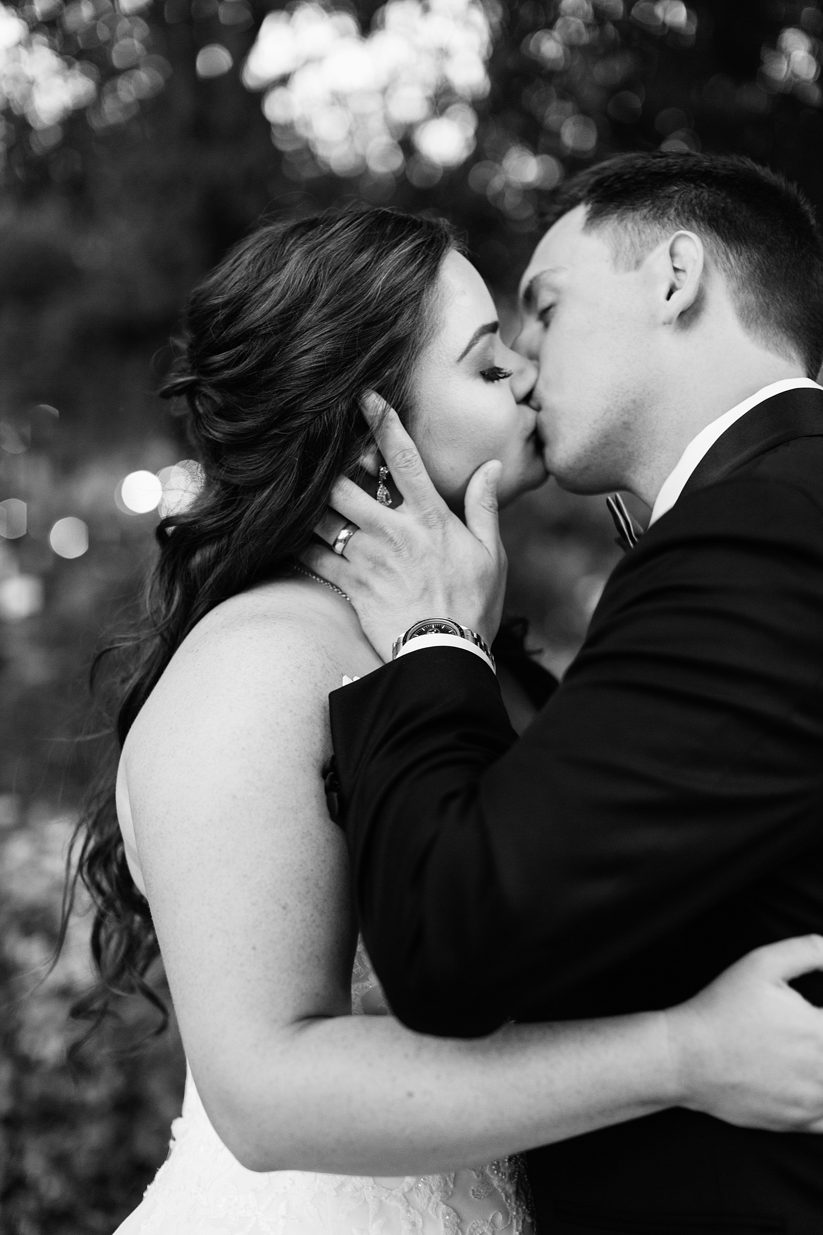 Bride and groom share a kiss during their Stonebridge Manor wedding by Mesa wedding photographer PMA Photography.