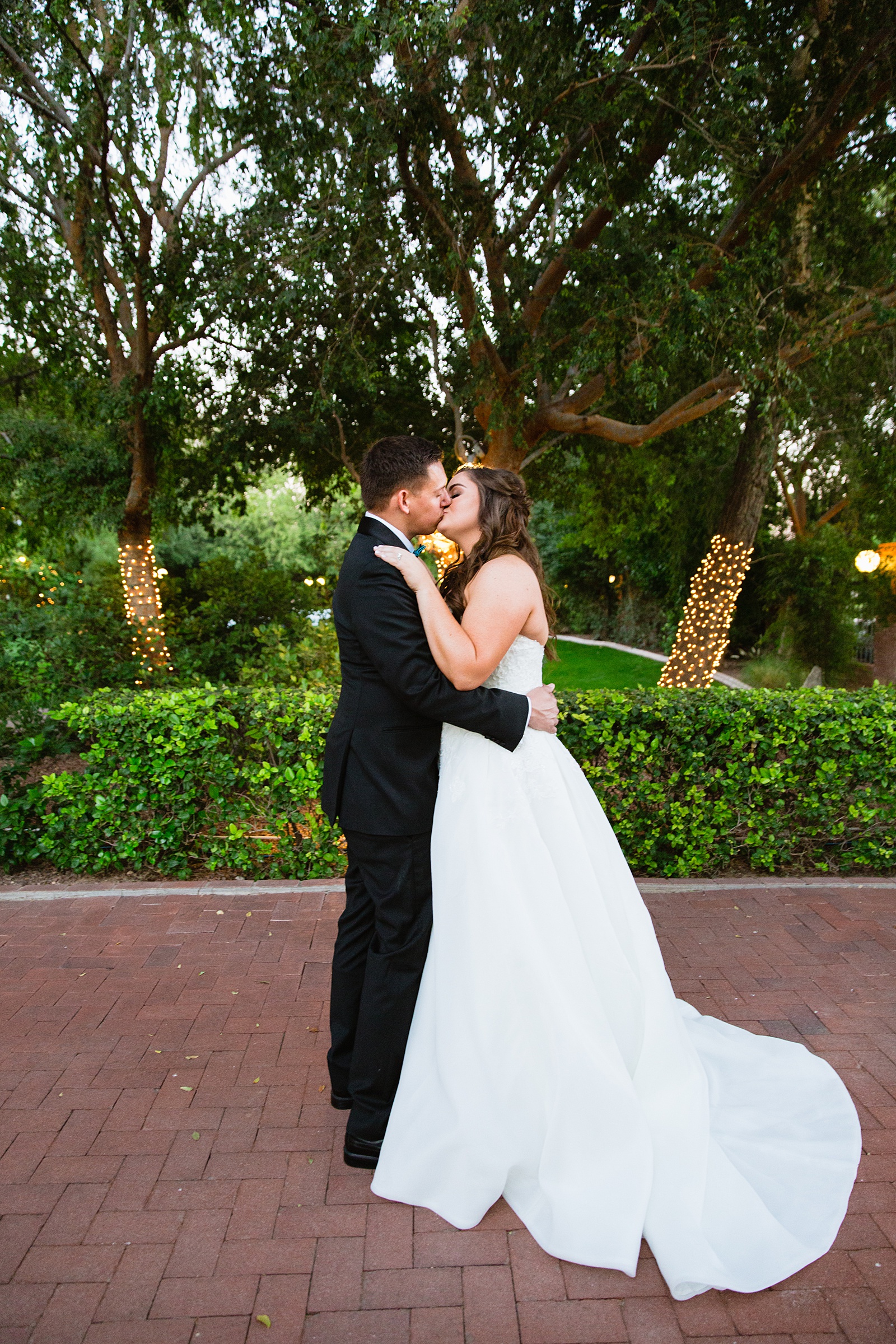 Bride and Groom share a kiss during their Stonebridge Manor wedding by Mesa wedding photographer PMA Photography.
