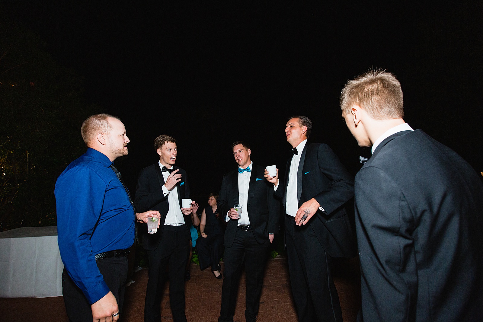 Groom hanging out with guests at Stonebridge Manor wedding reception by Mesa wedding photographer PMA Photography