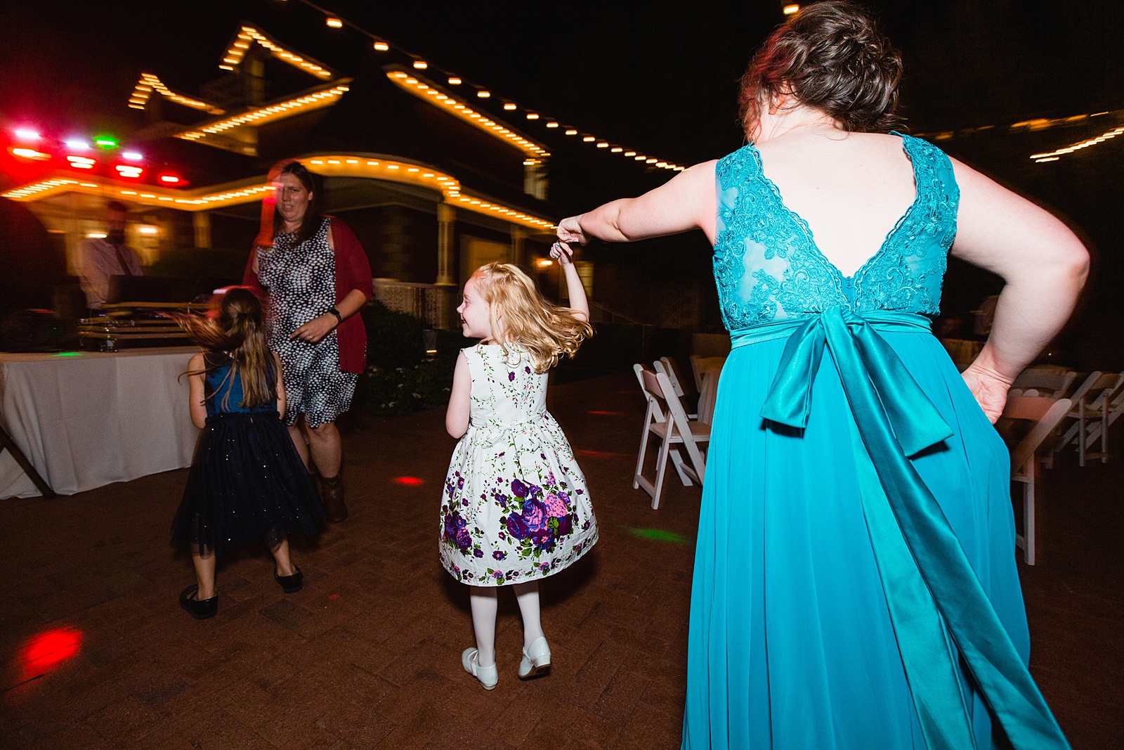 Guests dancing together at Stonebridge Manor wedding reception by Mesa wedding photographer PMA Photography