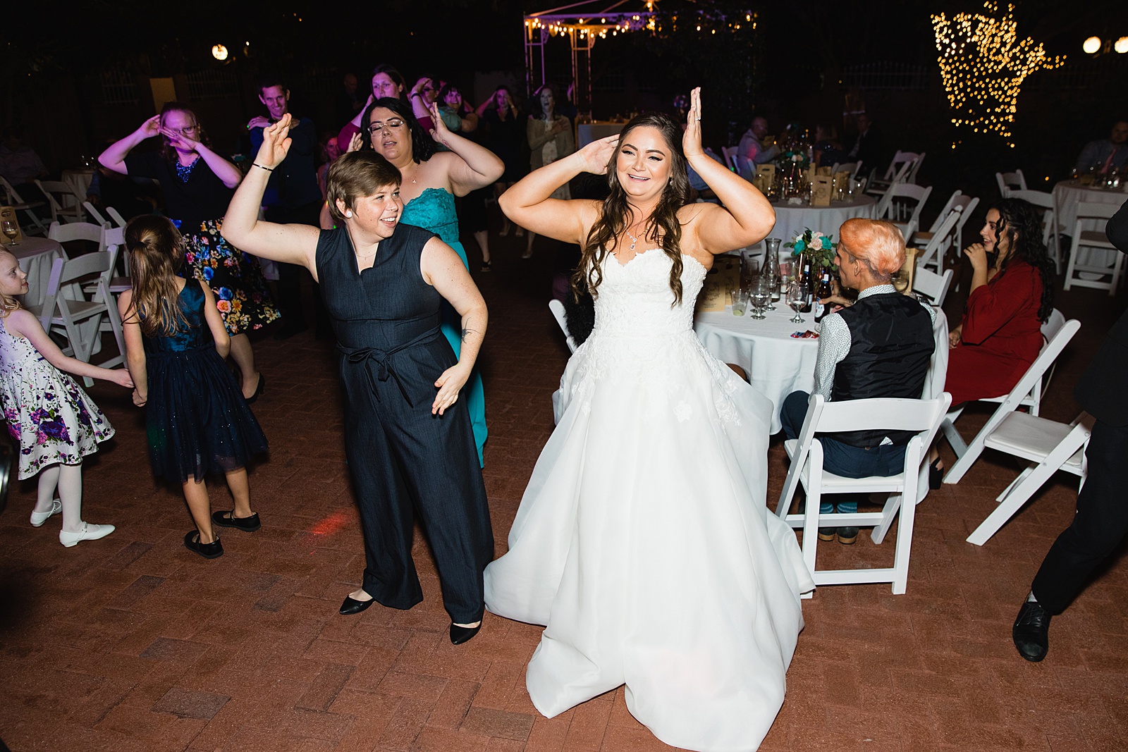 Bride dancing with guests at Stonebridge Manor wedding reception by Mesa wedding photographer PMA Photography