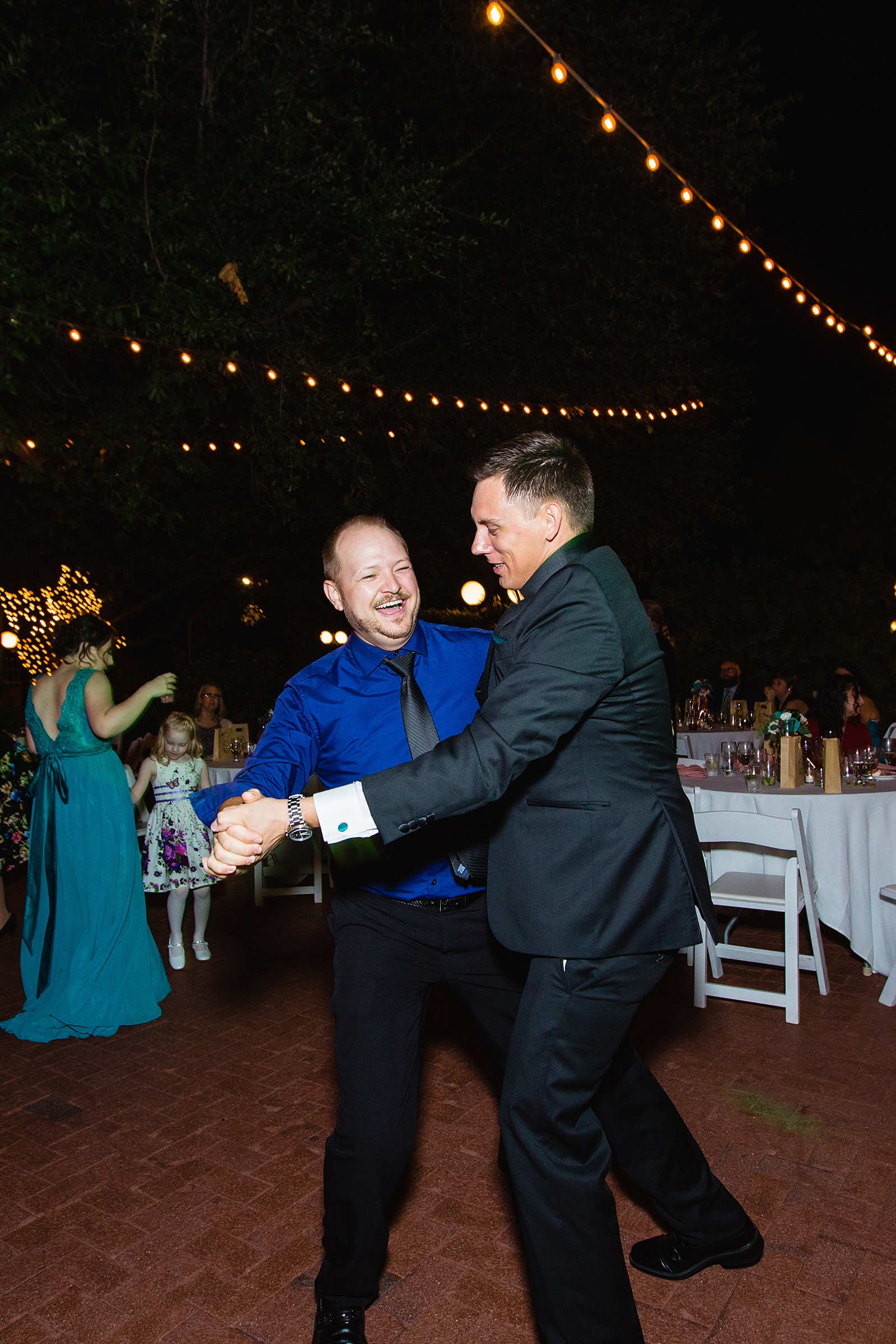 Groom dancing with guests at Stonebridge Manor wedding reception by Mesa wedding photographer PMA Photography