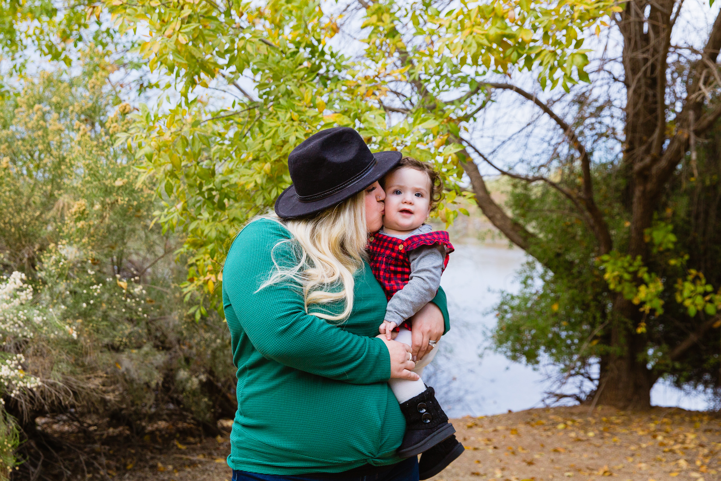 Expecting mother poses with her child during their Riparian Preserve at Water Ranch family session by Gilbert family photographer PMA Photography.