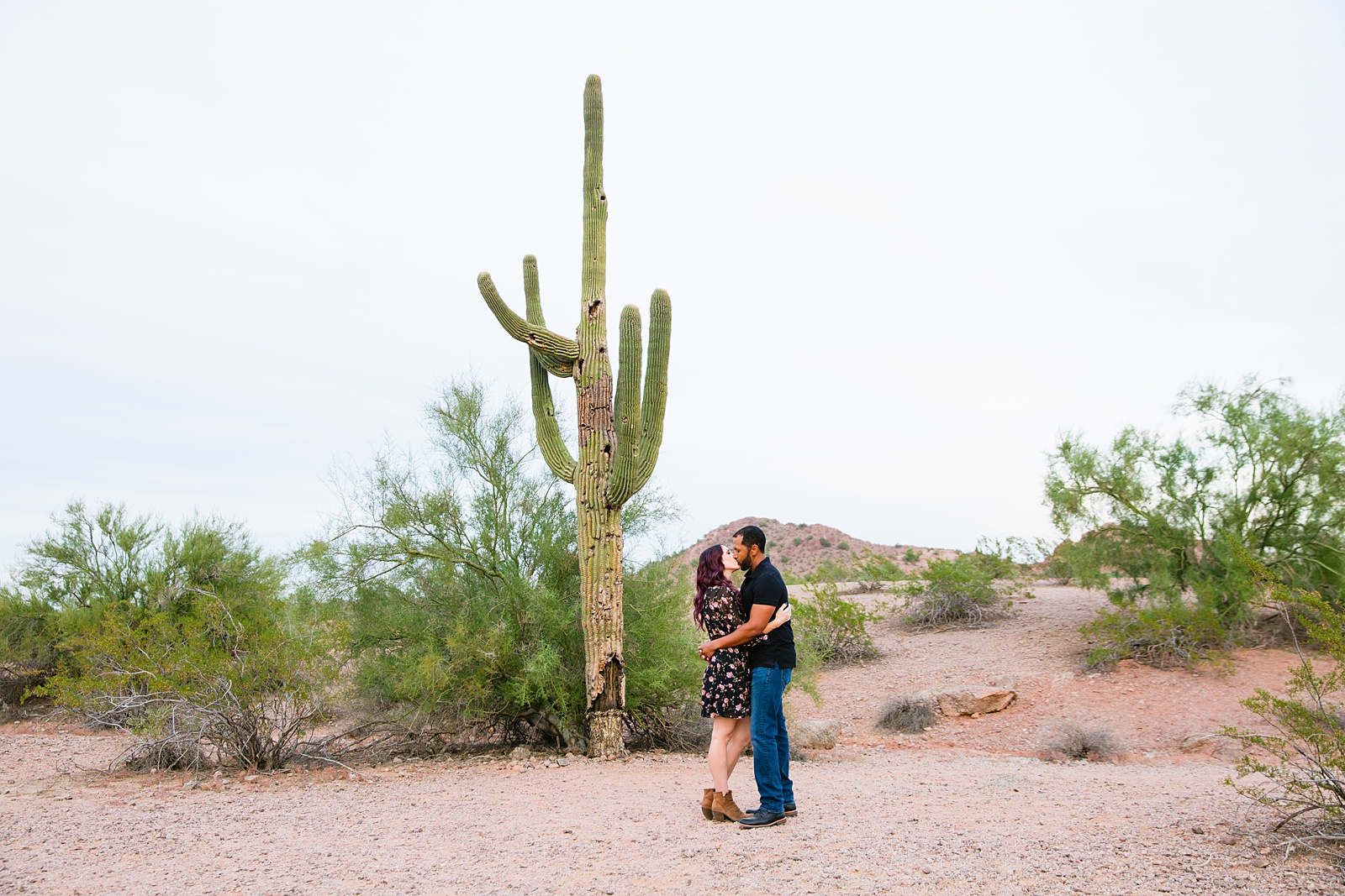 Couple share a kiss during their Papago Park engagement session by Phoenix wedding photographer PMA Photography.