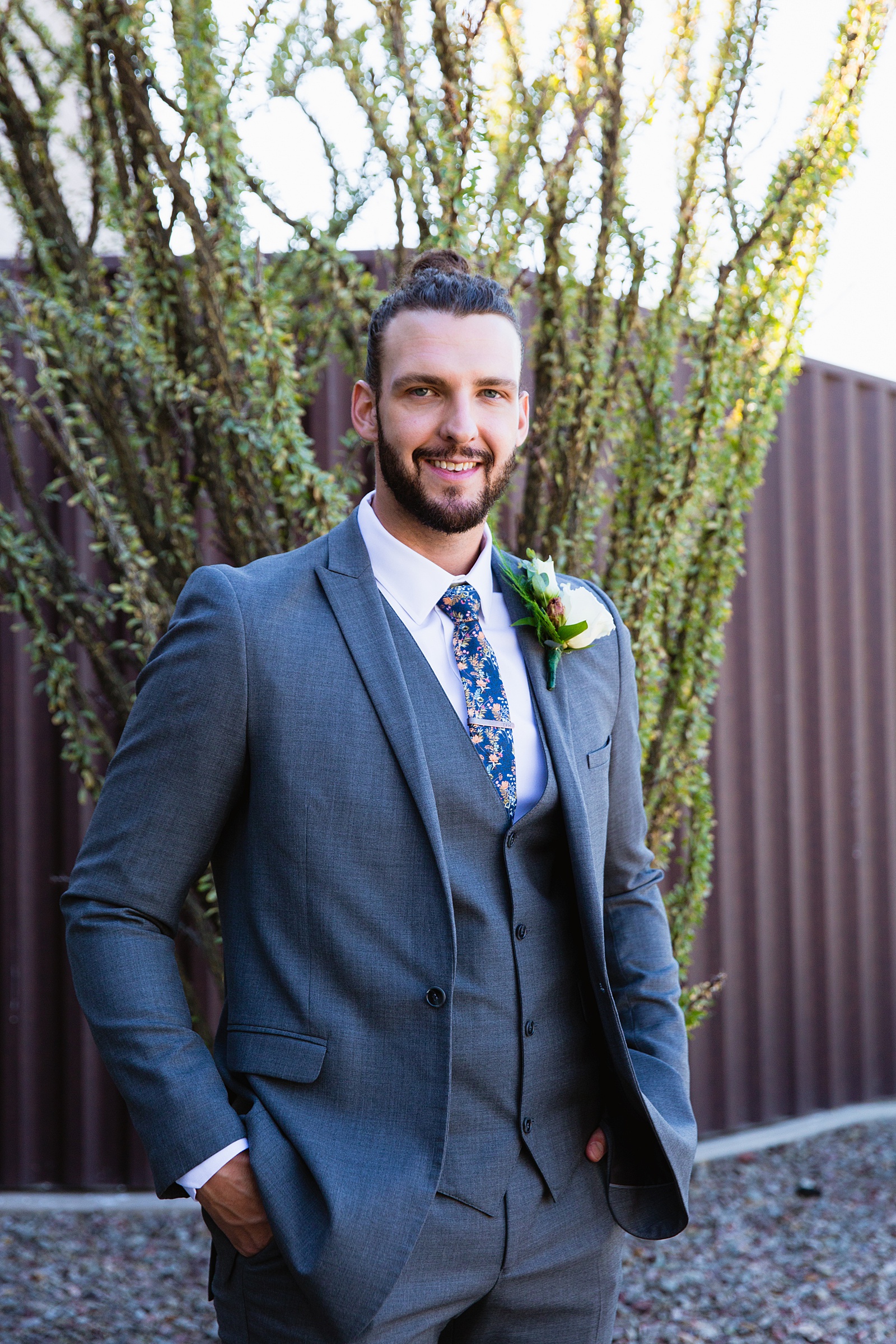 Groom's grey suit with floral tie for his Papago Events wedding by PMA Photography.