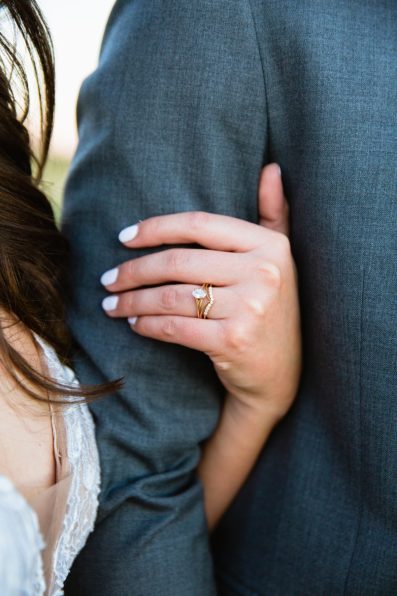 Close up image of the bride's unique engagement ring and wedding band by Arizona wedding photographer PMA Photography.