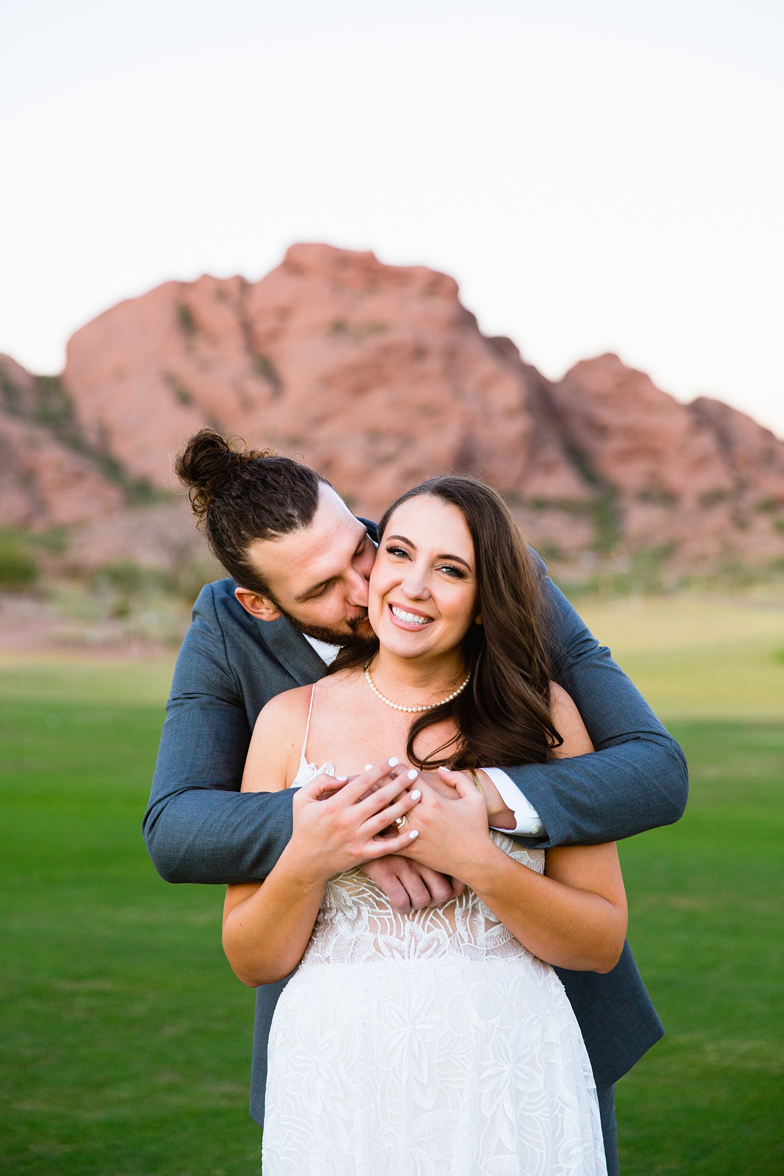 Bride and groom laughing together during their Papago Events wedding by Arizona wedding photographer PMA Photography.