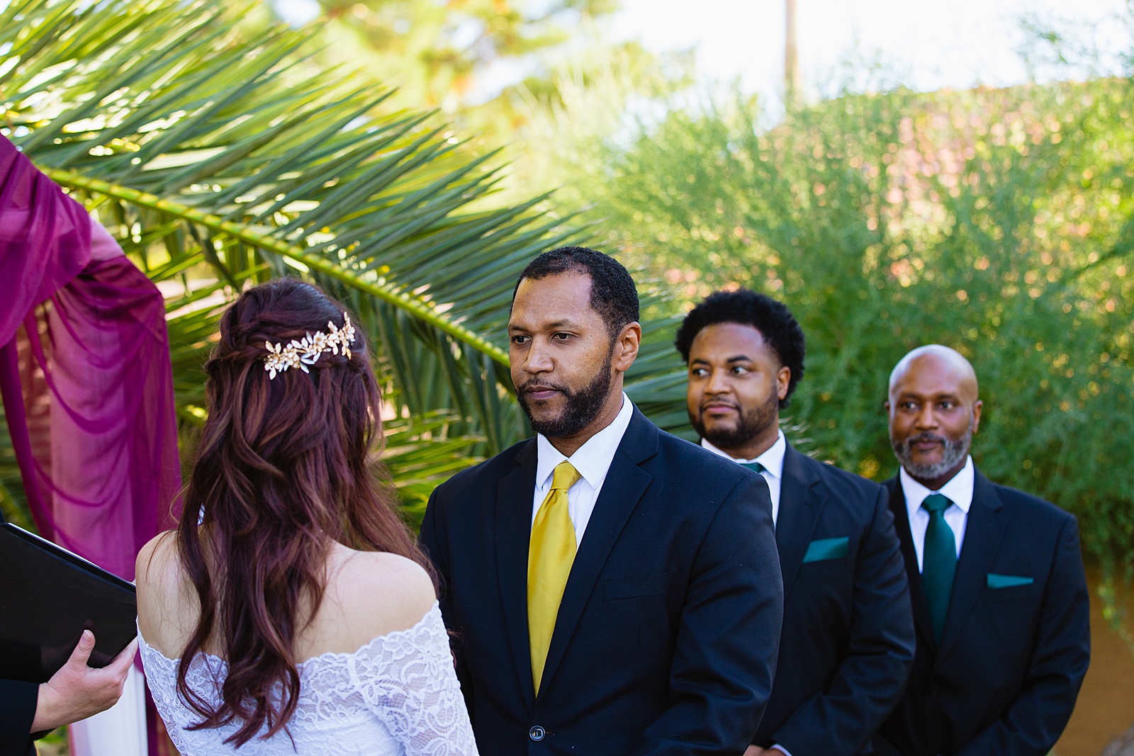 Groom looking at his bride during their wedding ceremony at Backyard Micro by Scottsdale wedding photographer PMA Photography.