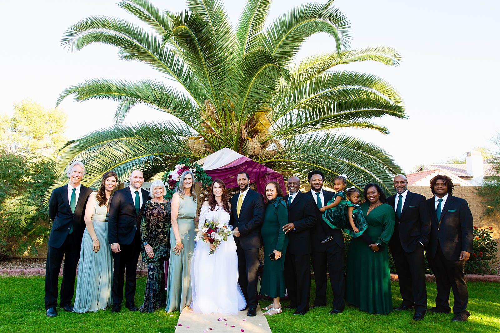 Bride and groom with their family at a Backyard Micro wedding by Arizona wedding photographer PMA Photography.