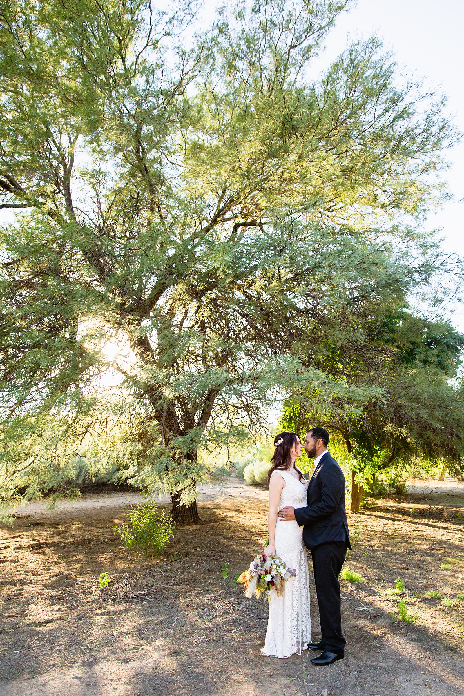 Bride and groom share an intimate moment at their Backyard Micro wedding by Arizona wedding photographer PMA Photography.