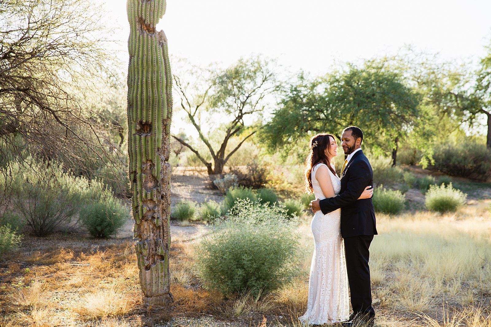 Bride and groom pose during their Backyard Micro wedding by Arizona wedding photographer PMA Photography.