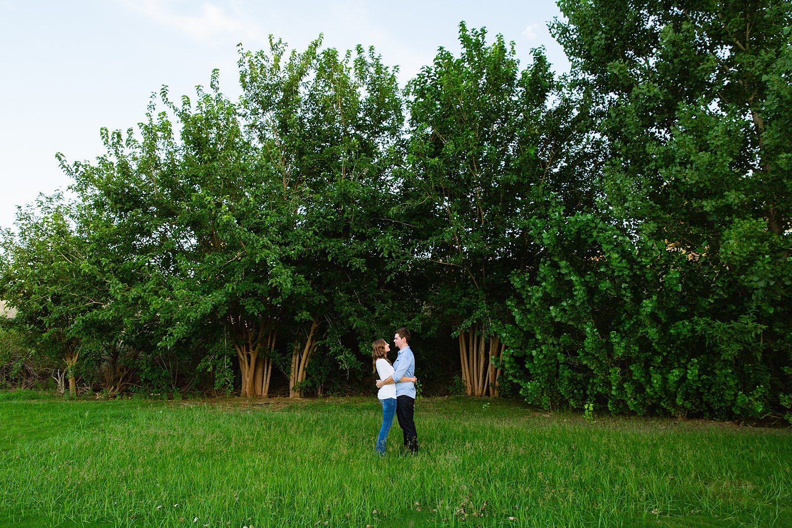 Couple pose for their Gilbert engagement session by Gilbert wedding photographer PMA Photography.
