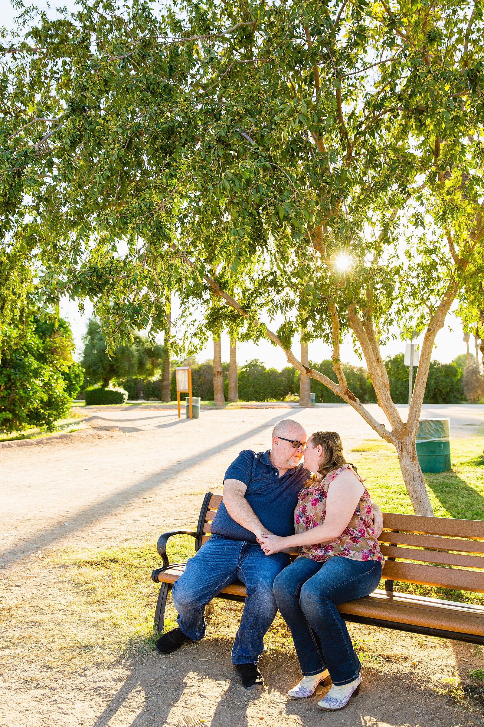 Couple share an intimate moment during their Sahuaro Ranch engagement session by Glendale engagement photographer PMA Photography.