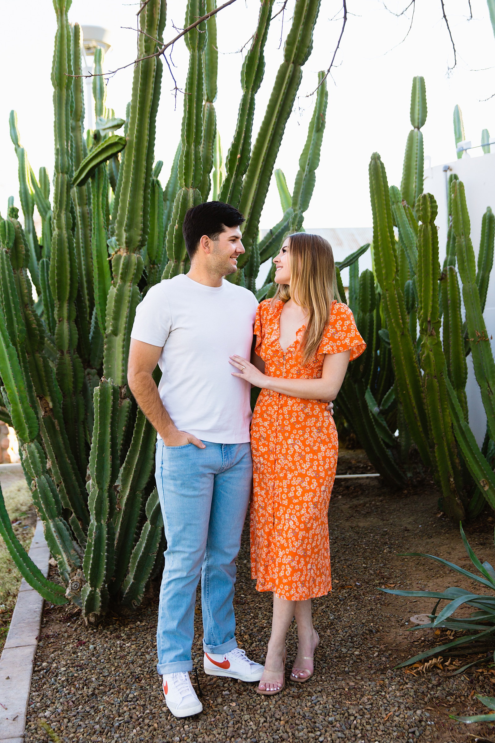 Couple look at each other during their Gilbert engagement session by Arizona wedding photographer PMA Photography.