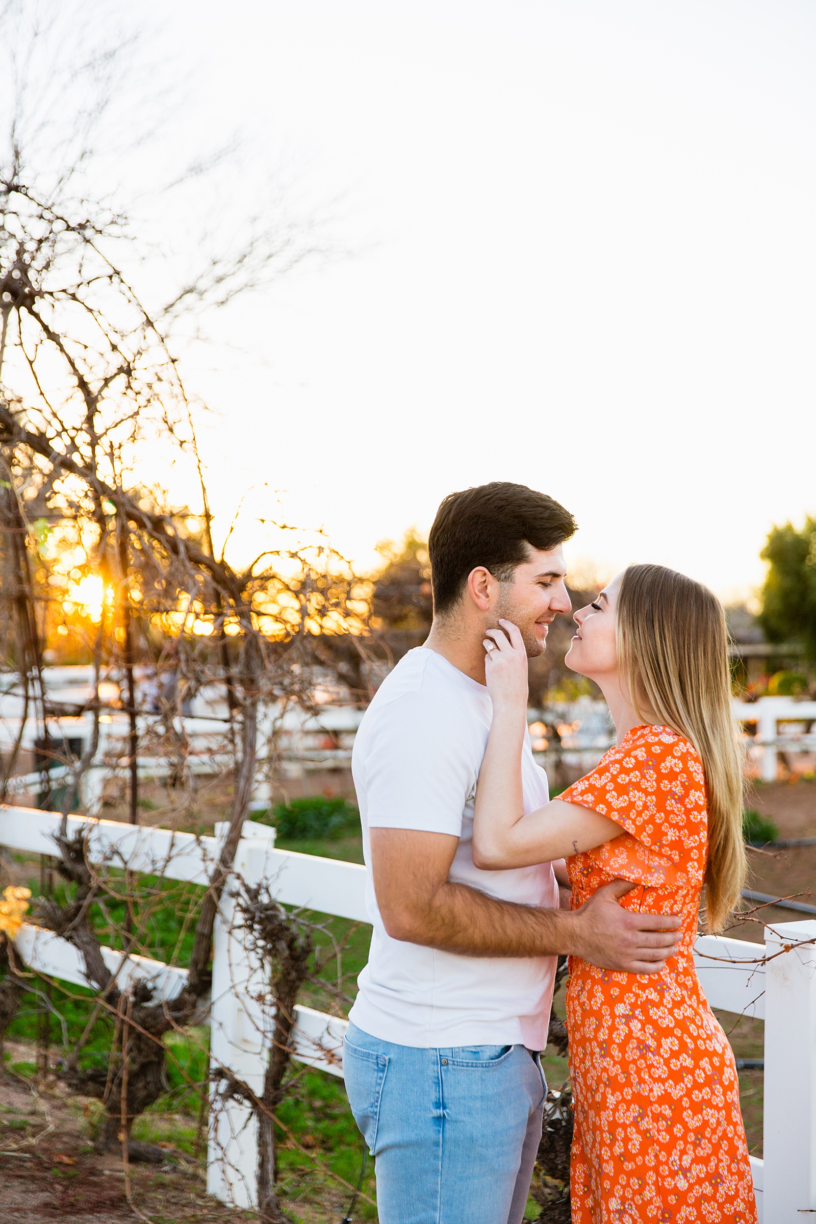 Couple share an intimate moment during their The Farm at Agritopia engagement session by Gilbert engagement photographer PMA Photography.