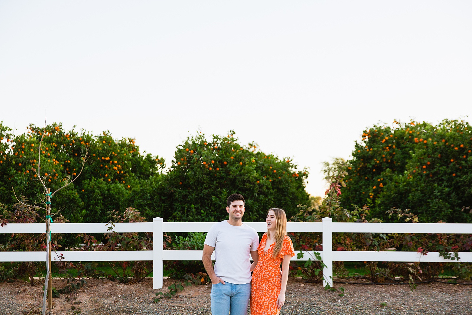 Couple having fun together during their The Farm at Agritopia engagement session by Gilbert engagement photographer PMA Photography.