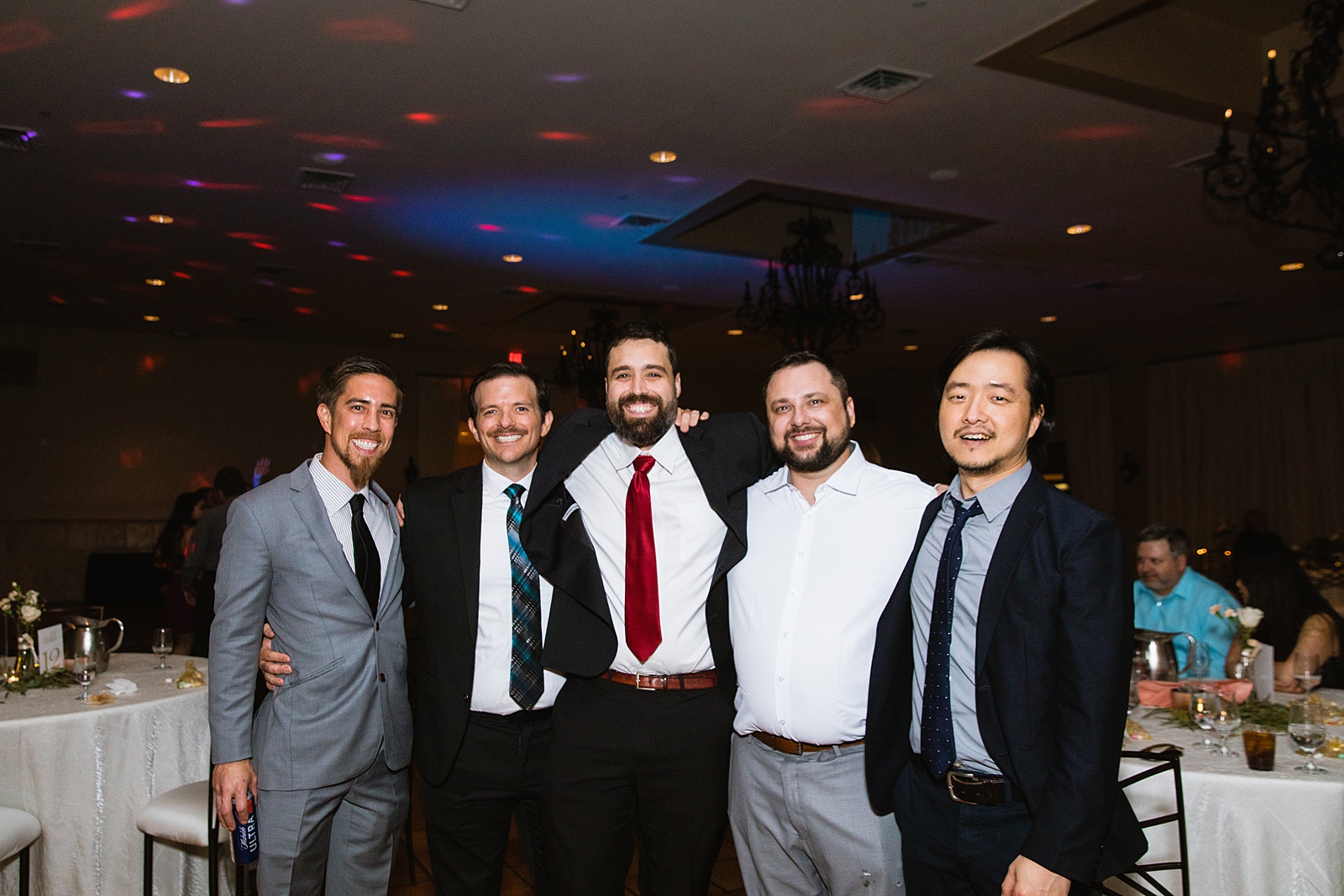 Groom with guests at Bella Rose Estate wedding reception by Chandler wedding photographer PMA Photography