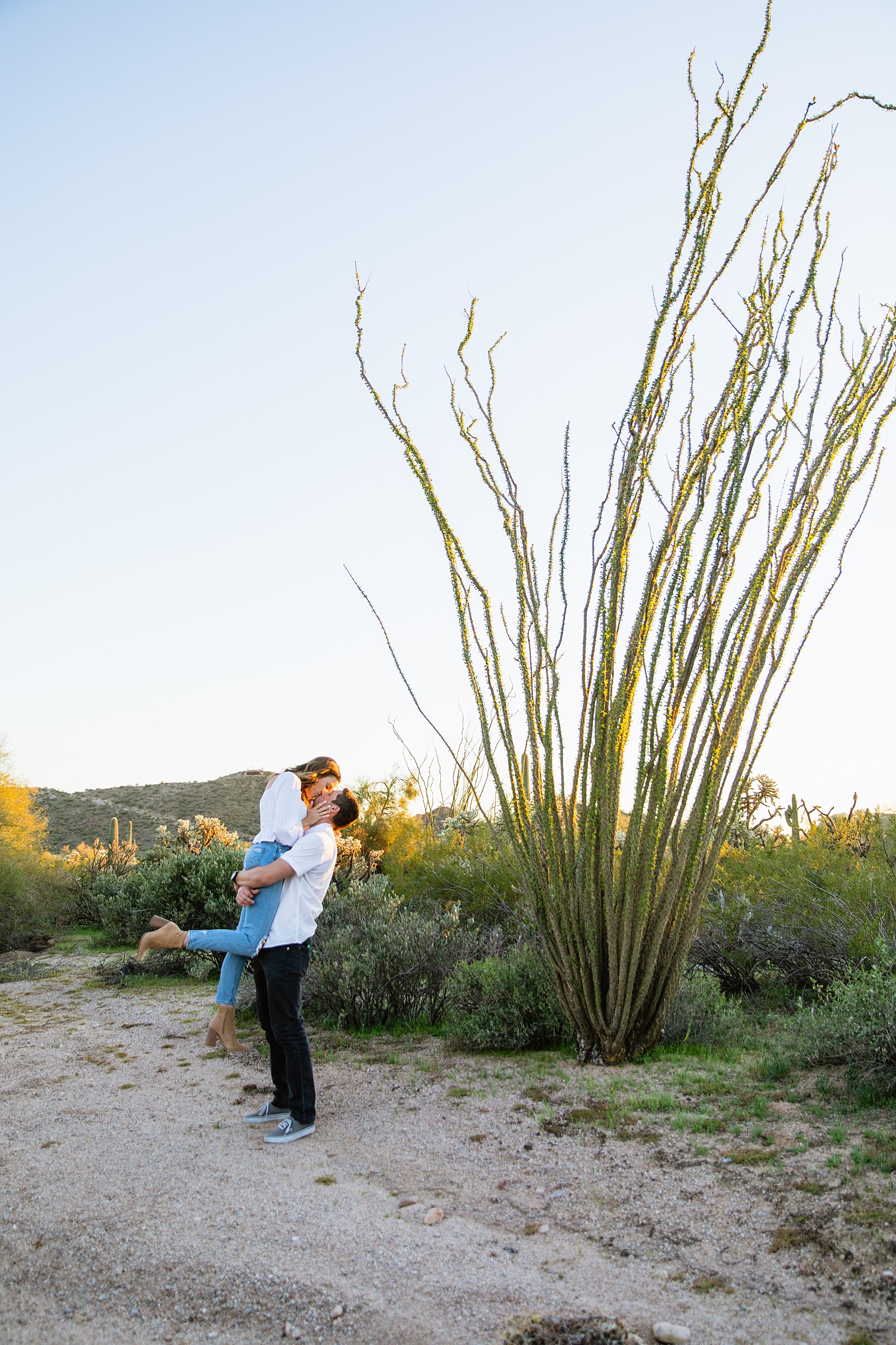 Couple pose for their desert engagement session by Phoenix wedding photographer PMA Photography.