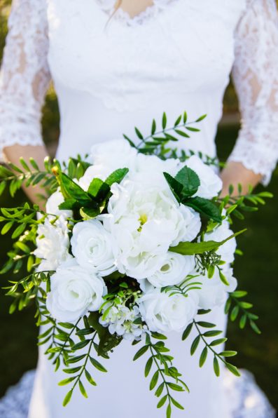 Bride's white and green artificial floral bouquet by PMA Photography.