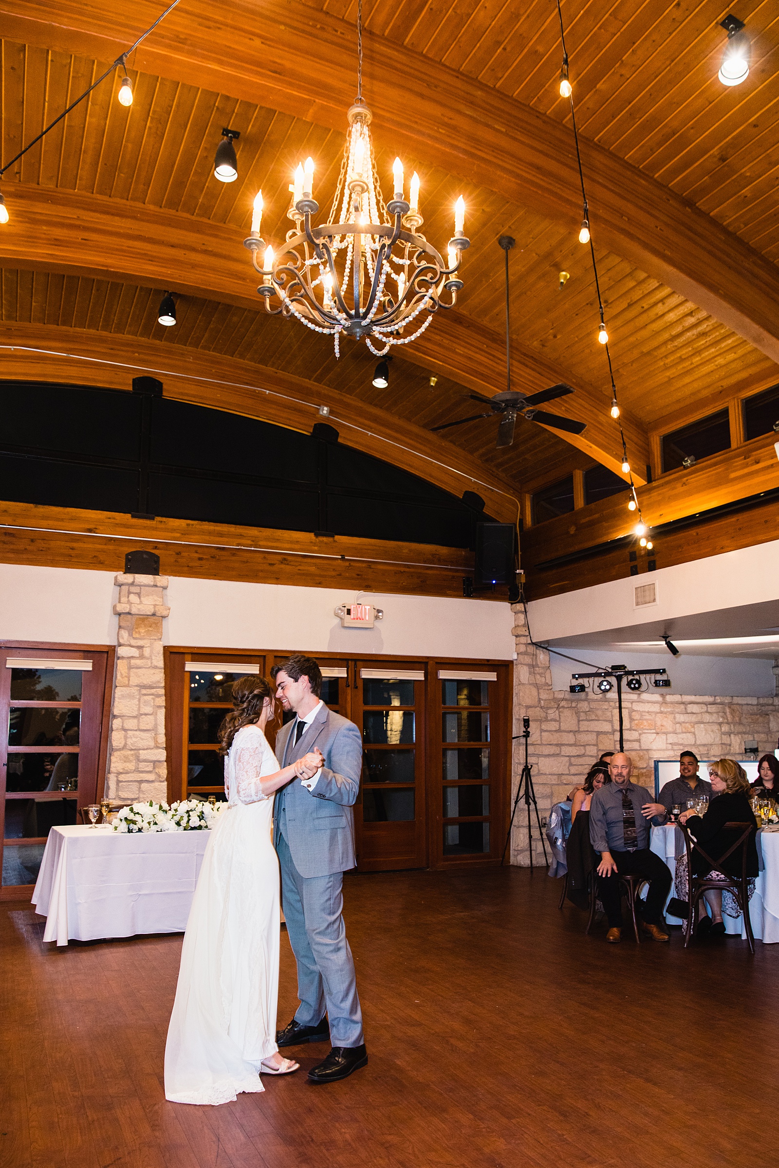 Newlyweds sharing first dance at their Ocotillo Oasis wedding reception by Arizona wedding photographer PMA Photography.
