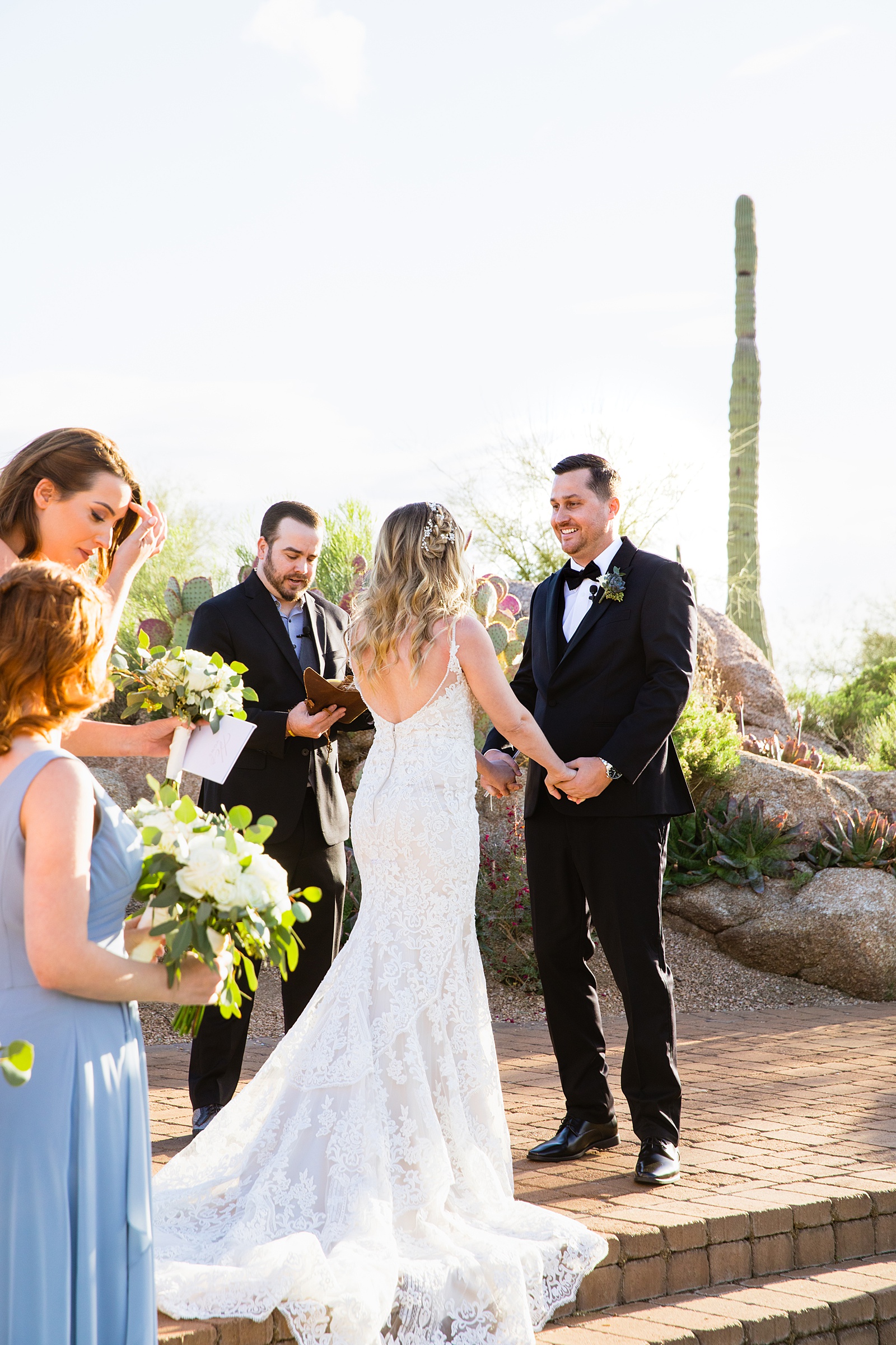 Groom looking at his bride during their wedding ceremony at Troon North by Scottsdale wedding photographer PMA Photography.