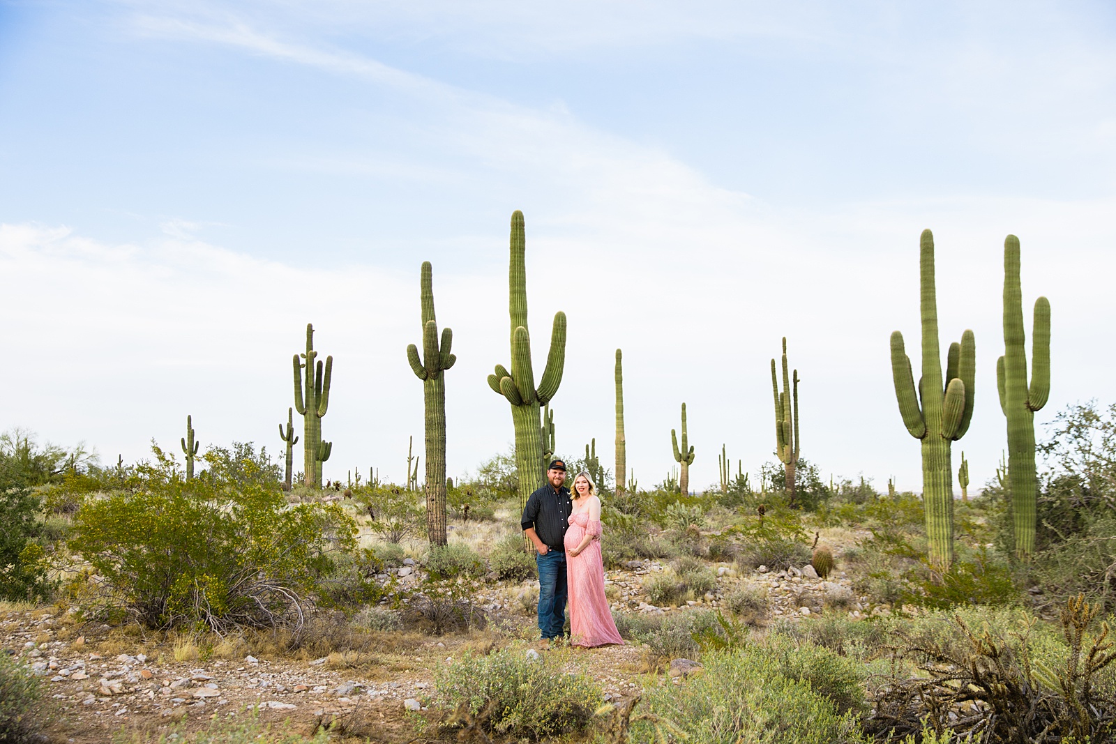 Couple pose during their Phoenix maternity session by Arizona maternity photographer PMA Photography.