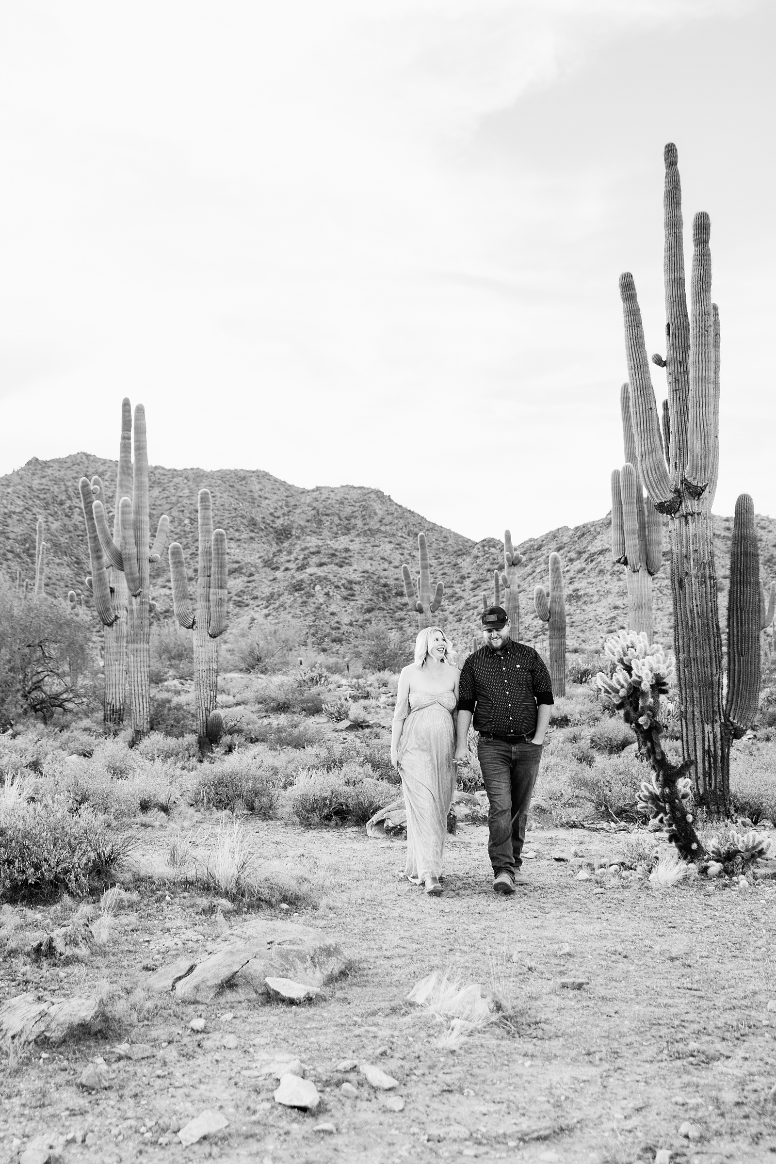 Couple walking together during their White Tanks Desert maternity session by Phoenix maternity photographer PMA Photography.