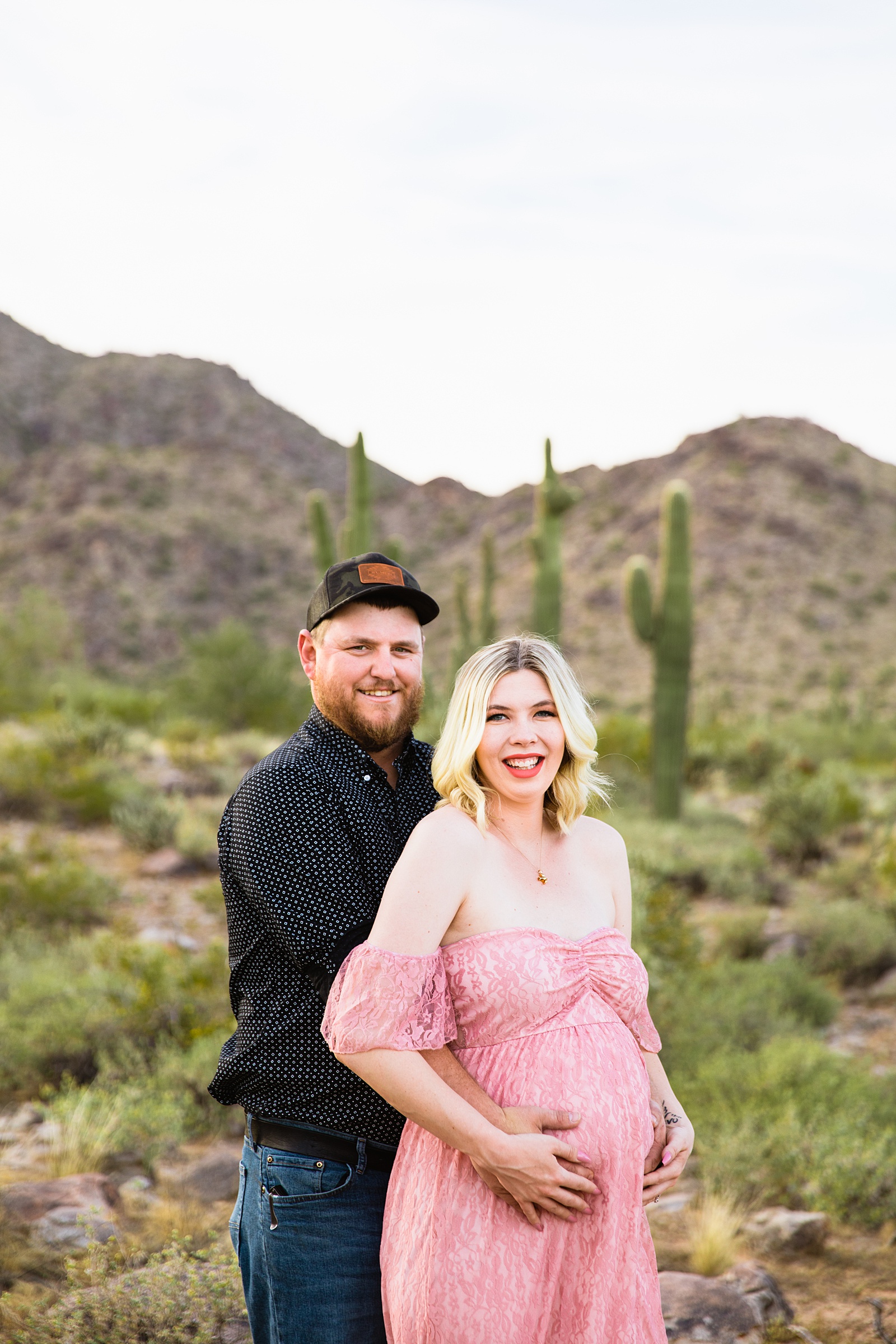 Couple pose during their Phoenix maternity session by Arizona maternity photographer PMA Photography.