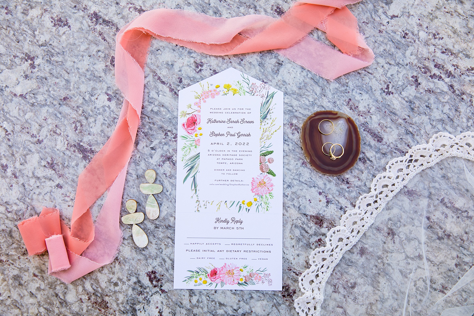 Brides's wedding day details of invitation, earings, rings and veil by PMA Photography.