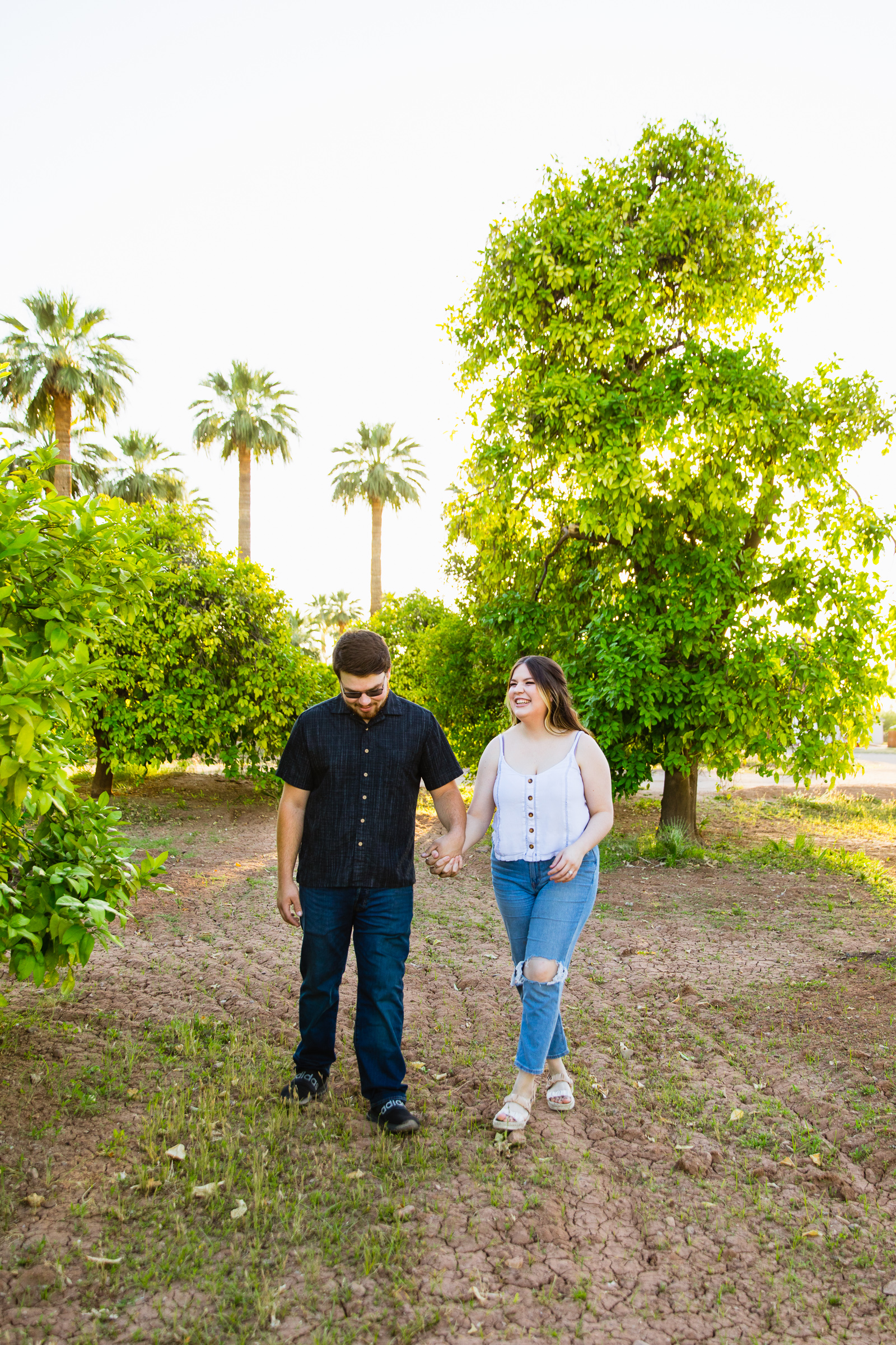 Couple walking together during their Glendale engagement session by Arizona engagement photographer PMA Photography.