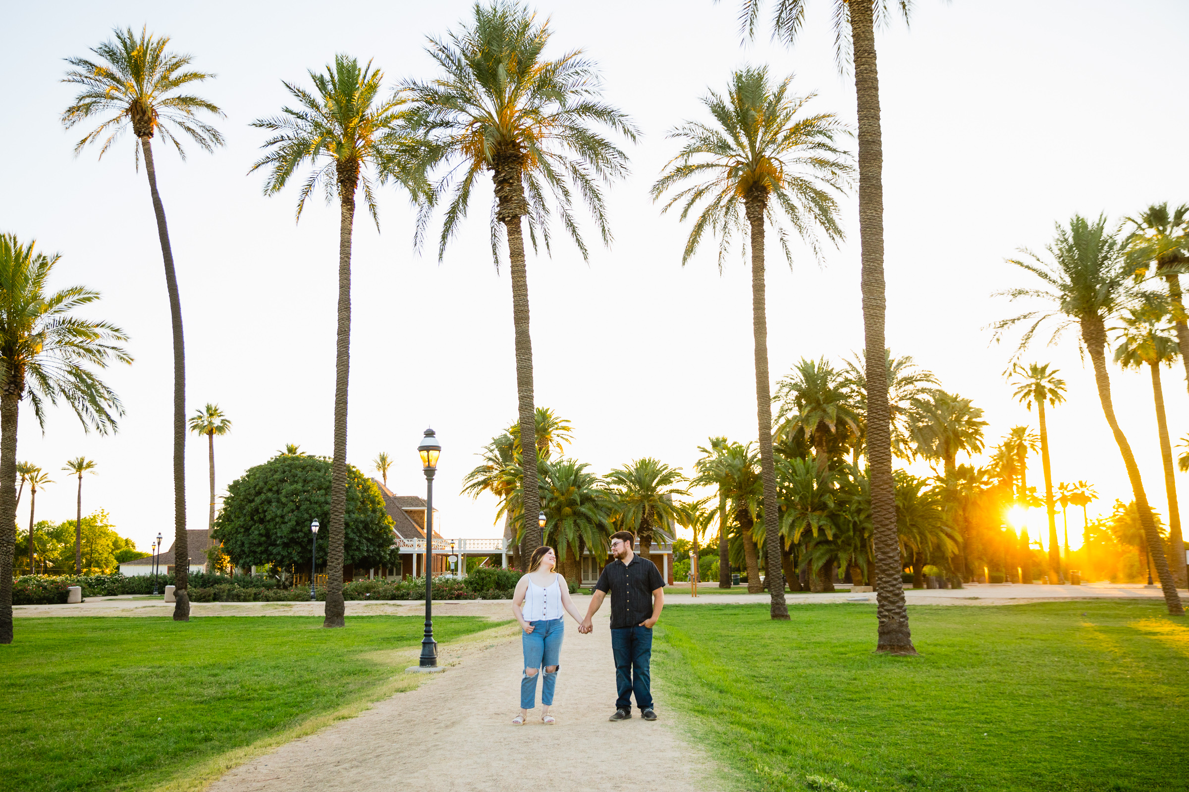 Couple look at each other during their Glendale engagement session by Arizona wedding photographer PMA Photography.