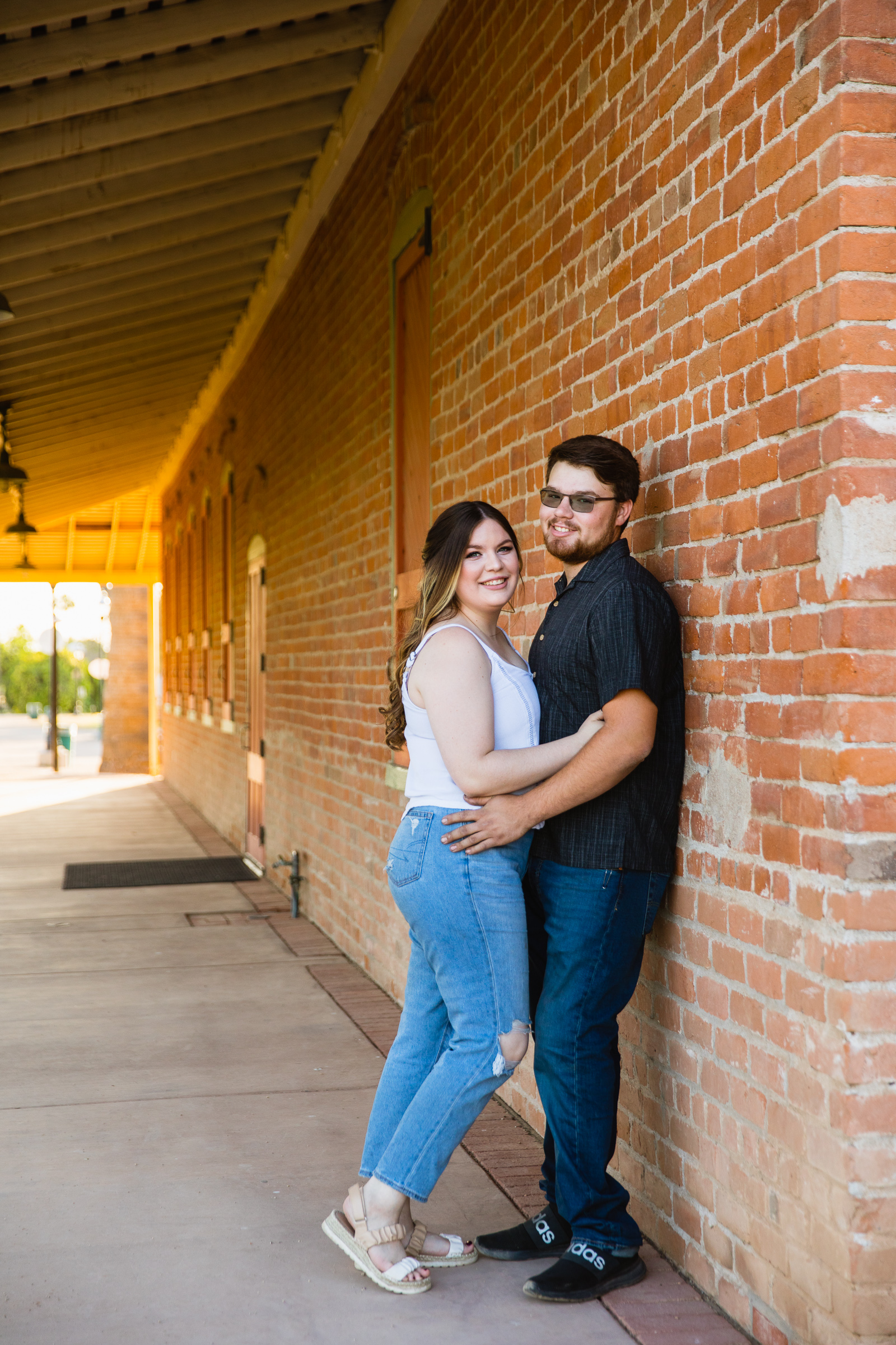 Couple pose during their Glendale engagement session by Arizona wedding photographer PMA Photography.