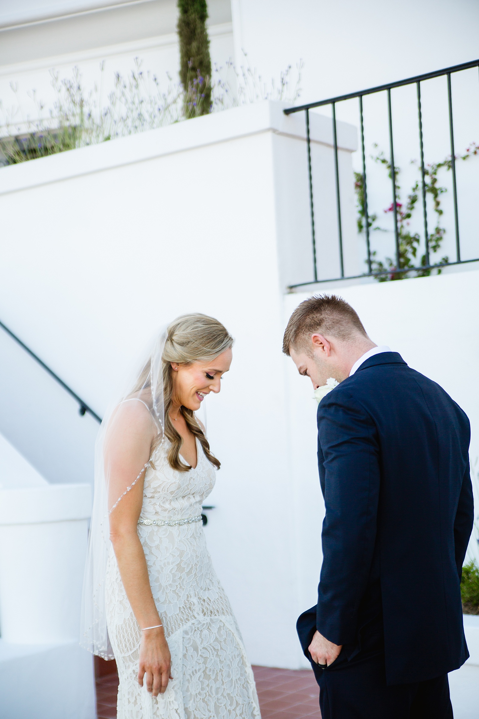 Bride and Groom share an intimate moment during their first look at Wrigley Mansion by Phoenix wedding photographer PMA Photography.