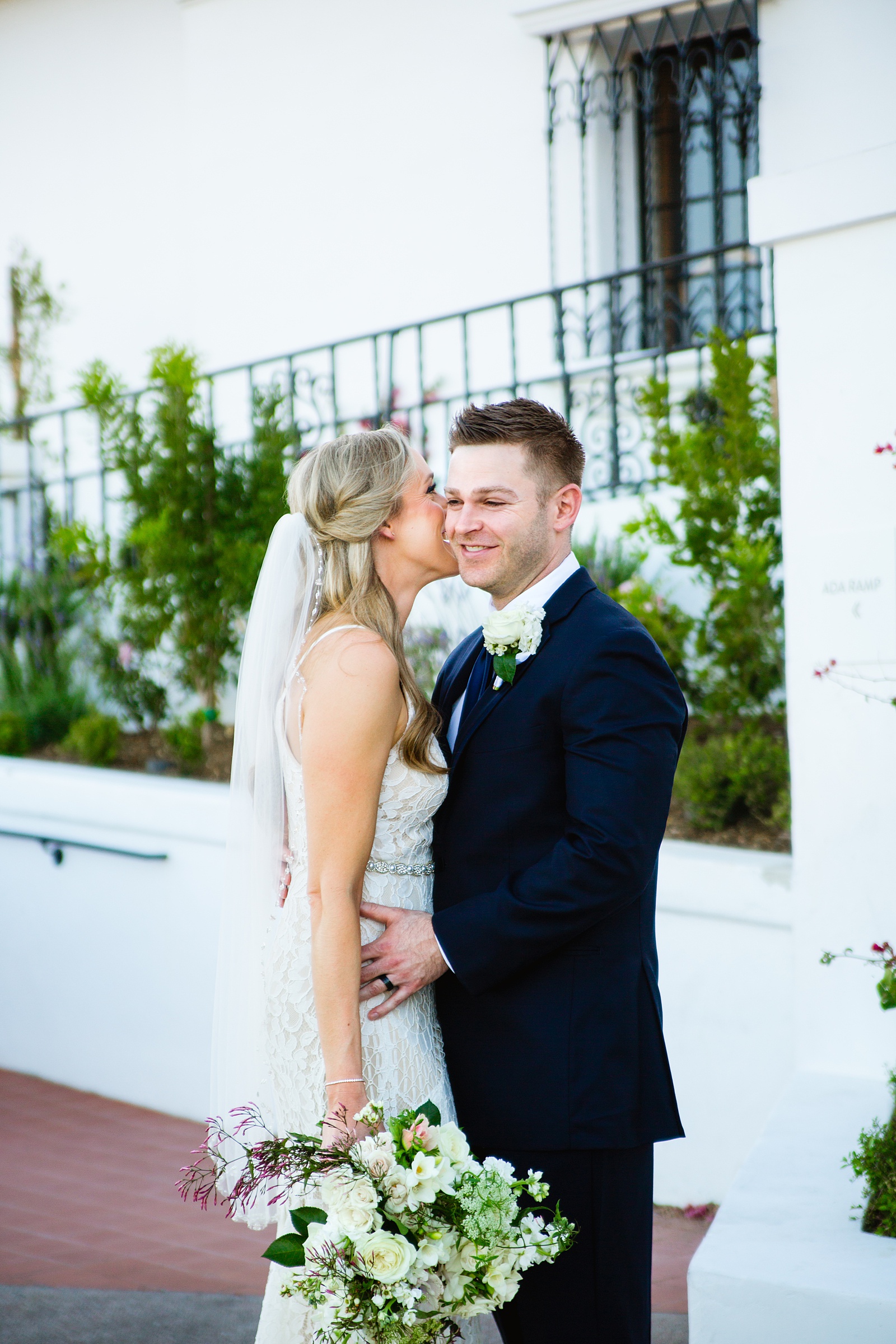 Bride and Groom laughing together during their Wrigley Mansion wedding by Arizona wedding photographer PMA Photography.
