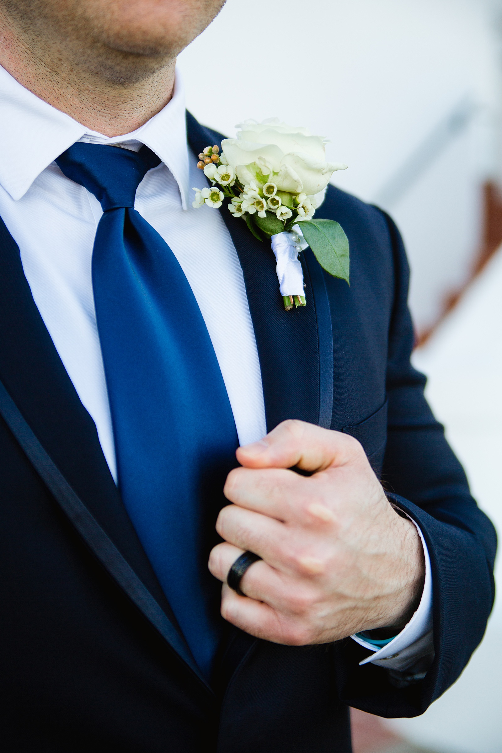Groom's classic white rose boutonniere by PMA Photography.