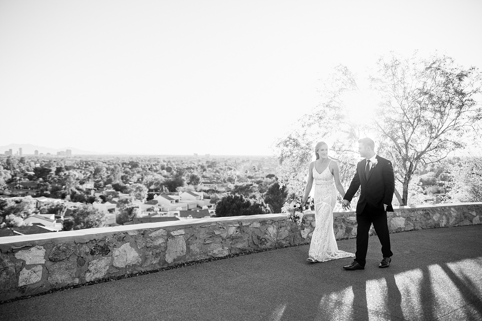 Bride and Groom walking together during their Wrigley Mansion wedding by Arizona wedding photographer PMA Photography.