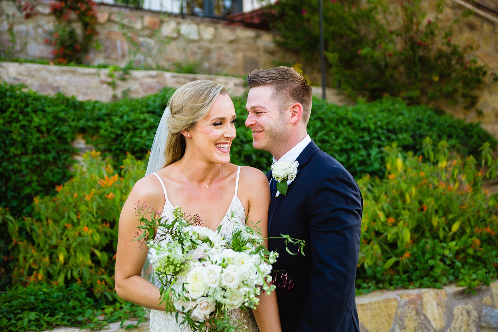 Bride and Groom laughing together during their Wrigley Mansion wedding by Phoenix wedding photographer PMA Photography.