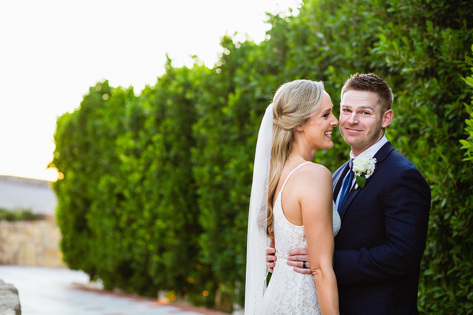 Bride and Groom laughing together during their Wrigley Mansion wedding by Arizona wedding photographer PMA Photography.