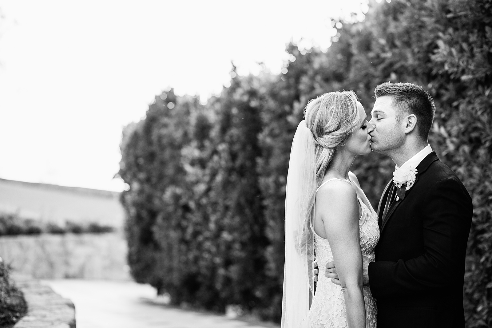 Bride and Groom share a kiss during their Wrigley Mansion wedding by Arizona wedding photographer PMA Photography.