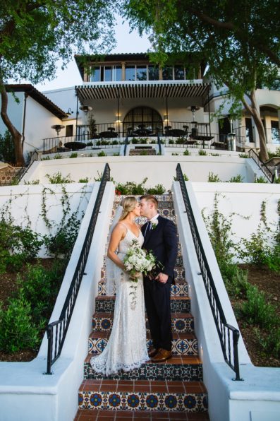 Bride and Groom share a kiss during their Wrigley Mansion wedding by Phoenix wedding photographer PMA Photography.