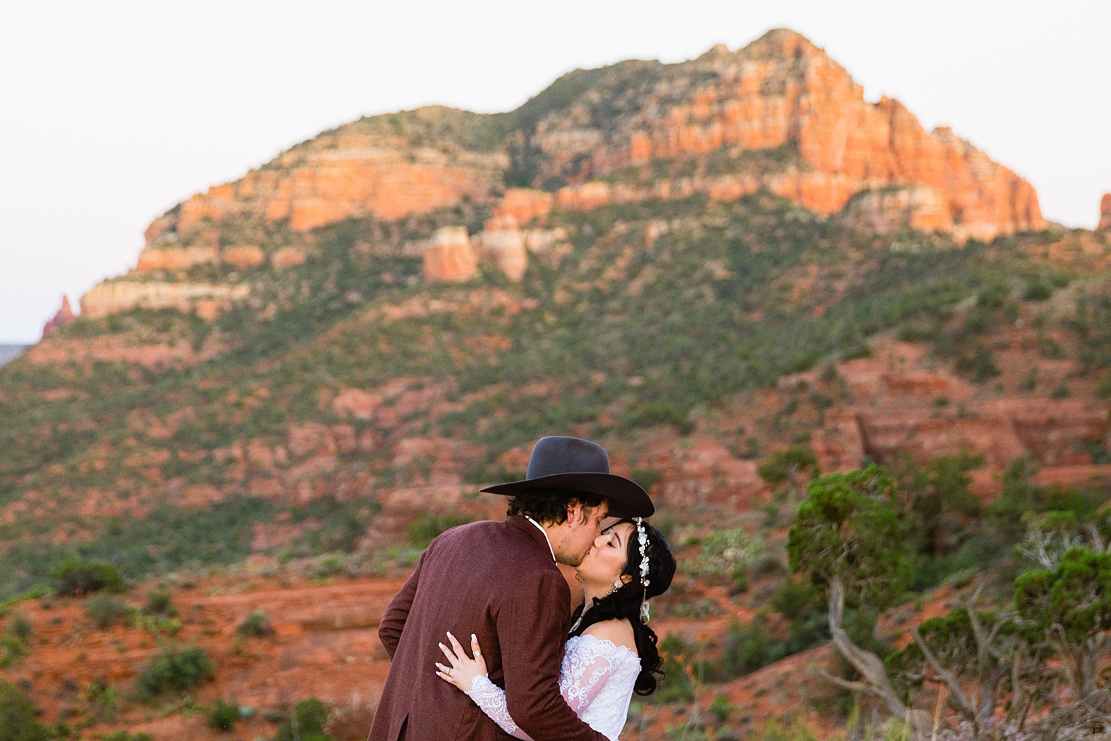 Bride and Groom share a kiss during their Cathedral Rock elopement by Sedona elopement photographer PMA Photography.