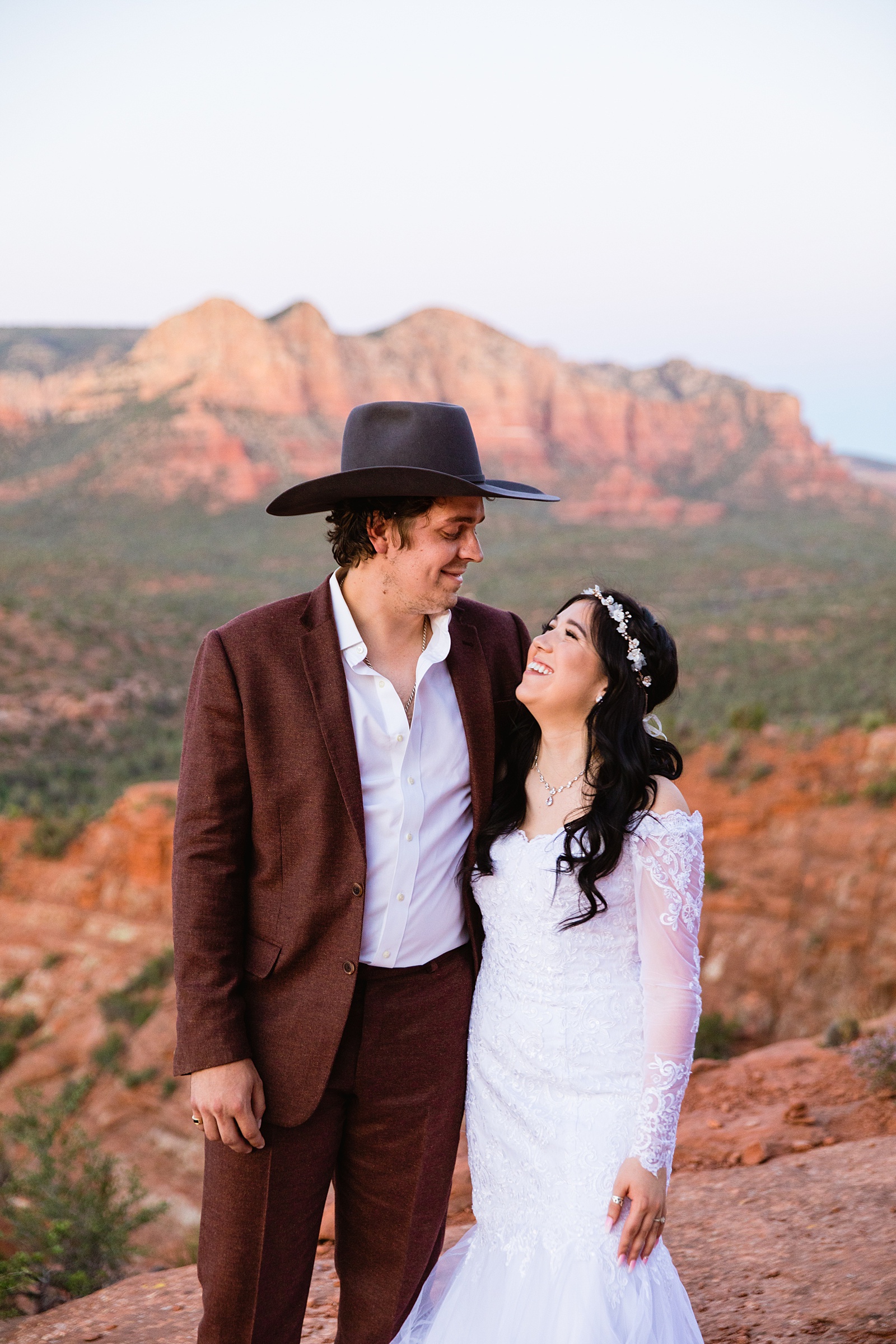 Bride and Groom laughing together during their Cathedral Rock elopement by Sedona elopement photographer PMA Photography.