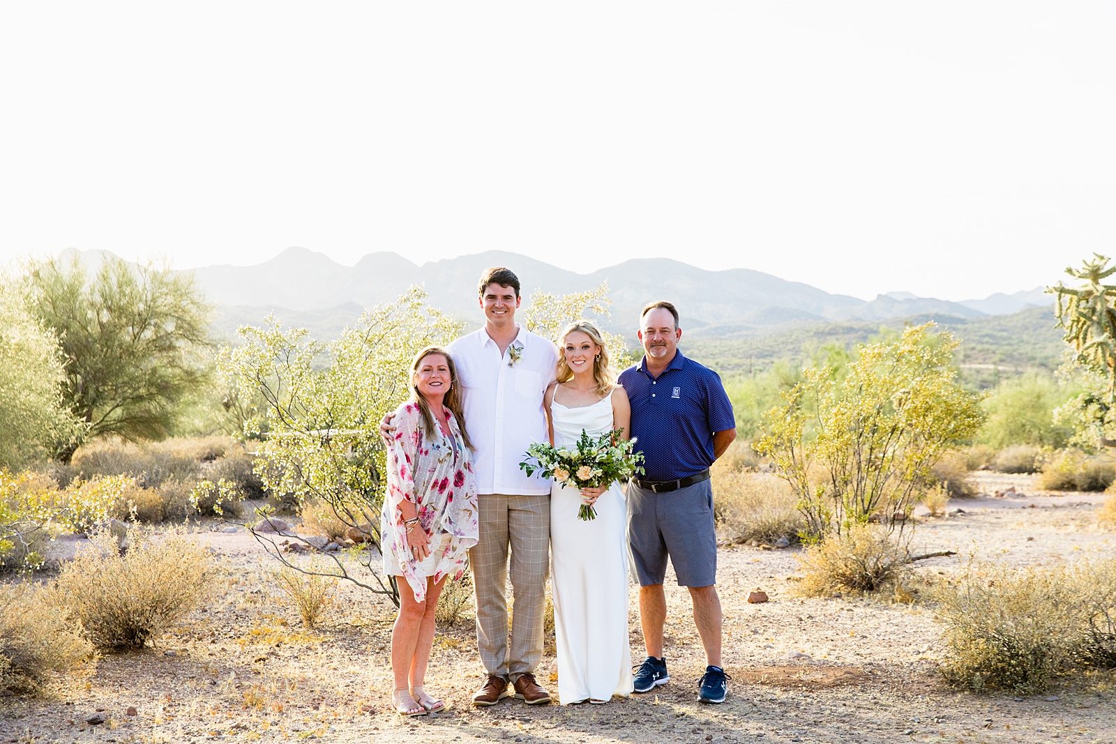 Bride and groom pose with family during their Superstition Mountain Micro wedding by Lost Dutchman wedding photographer PMA Photography.