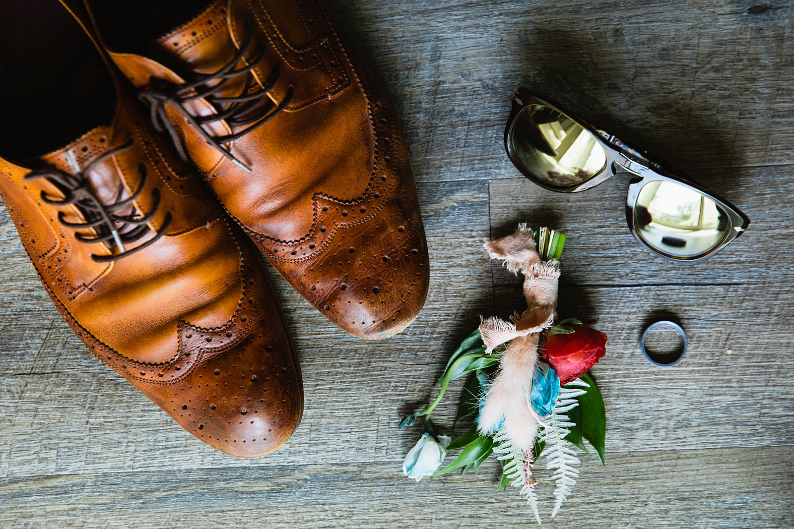 Groom's wedding day details of shoes, sunglasses, boutonniere and wedding ring by PMA Photography.