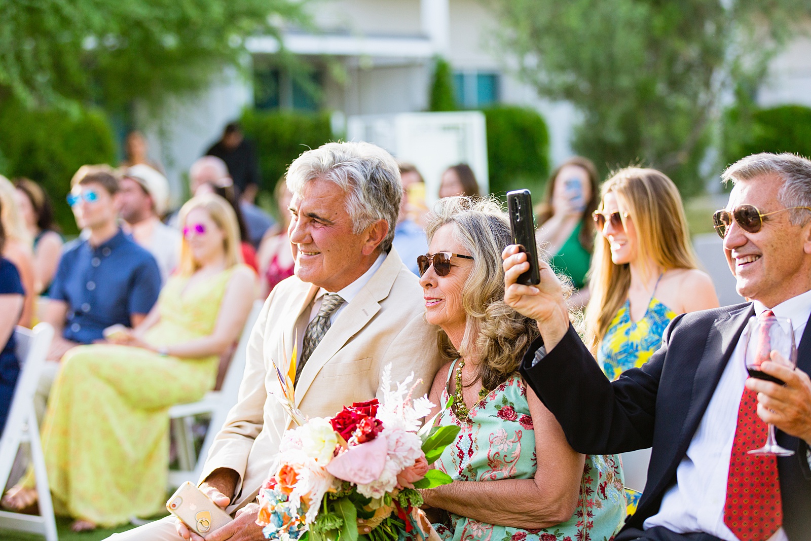 Wedding guests watching the wedding ceremony at Mountain Shadows Resort by Paradise Valley wedding photographer PMA Photography.