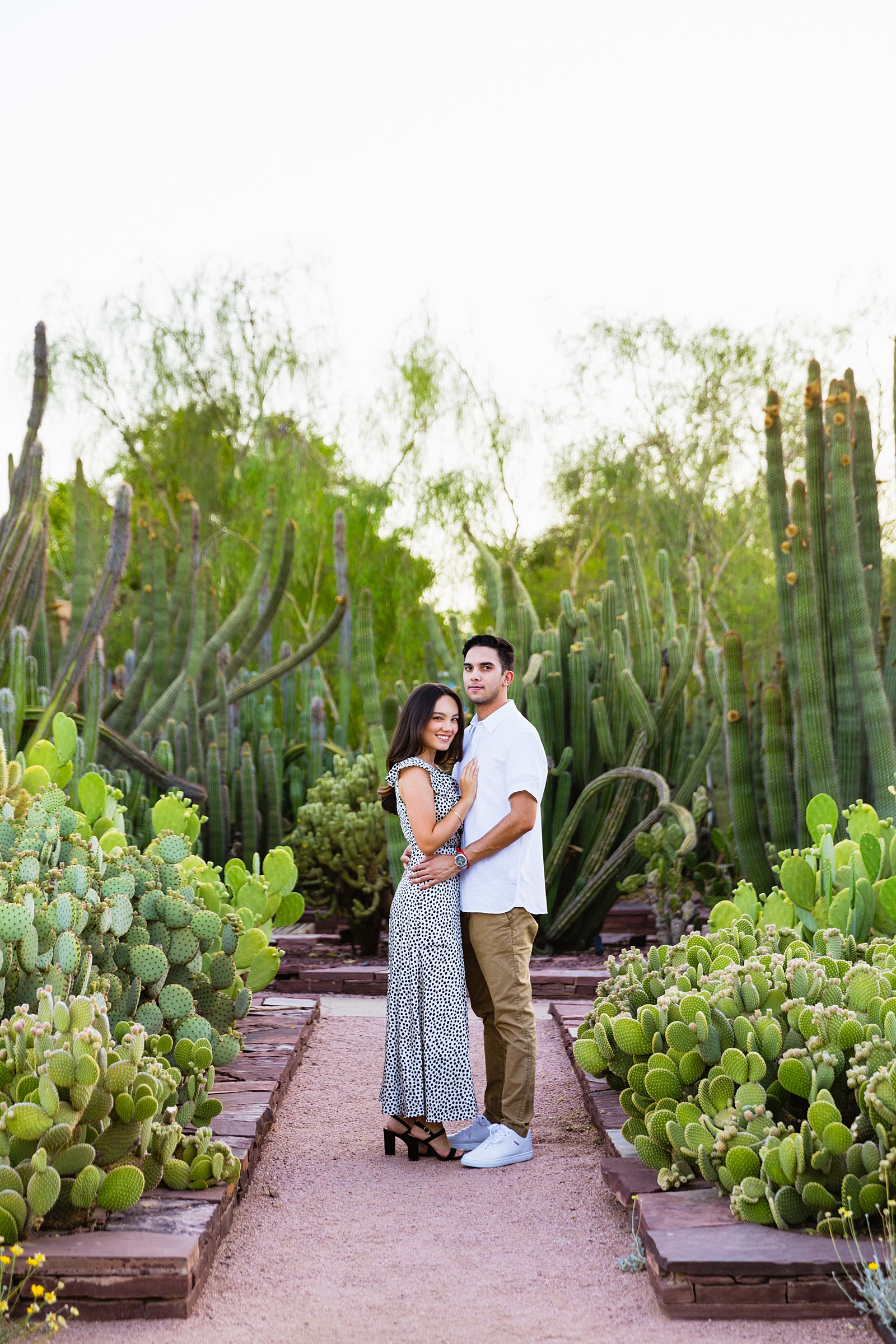 Couple pose for their Desert Botanical Garden engagement session by Phoenix wedding photographer PMA Photography.